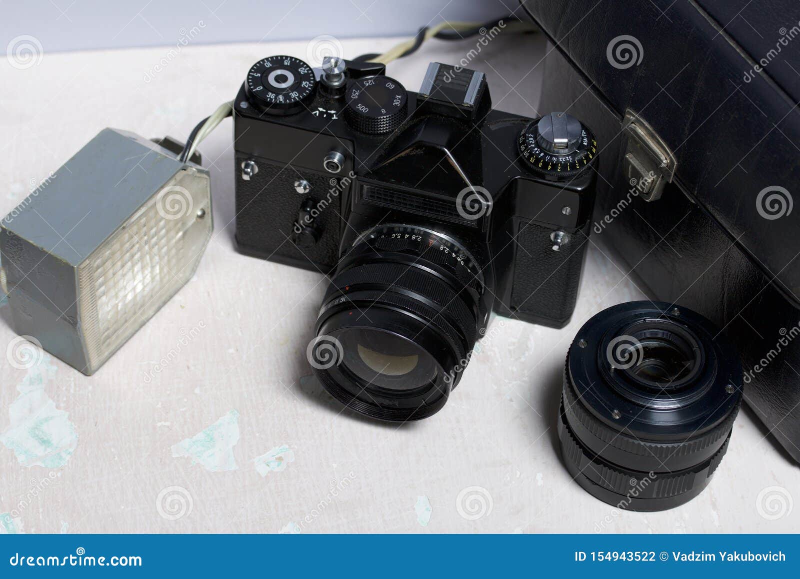 Old Film Camera, Removable Lens and Wired Flash. they Lie on the