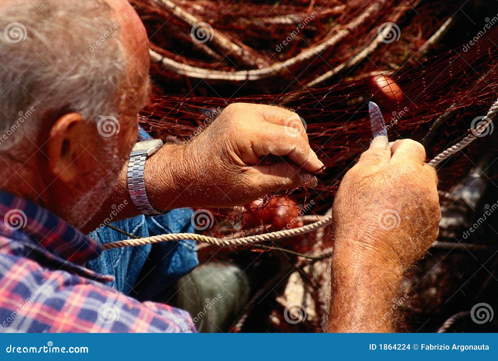 old fisherman mending net