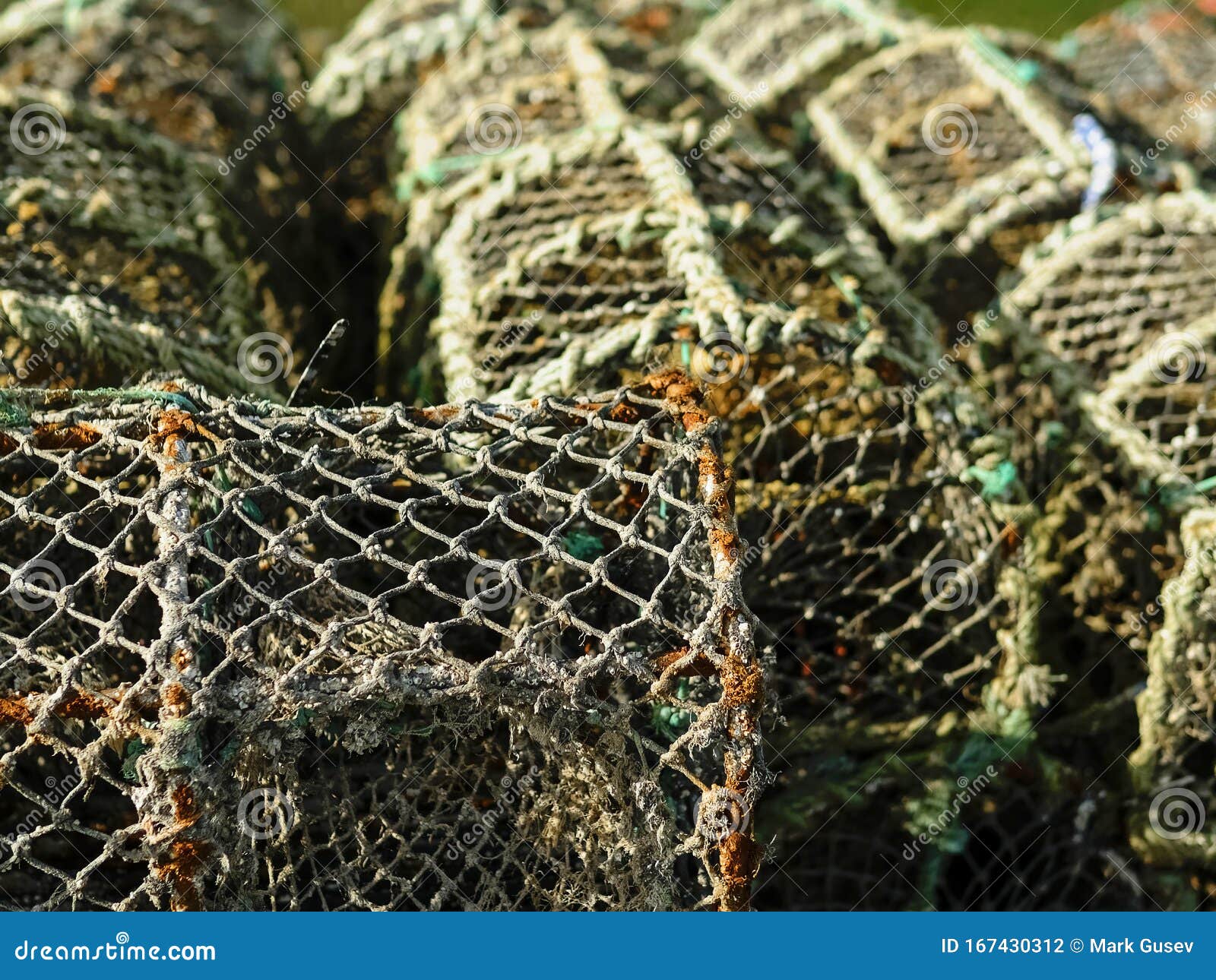 https://thumbs.dreamstime.com/z/old-fishing-traps-selective-focus-used-fish-crab-trap-close-up-rusty-metal-frame-covered-net-167430312.jpg