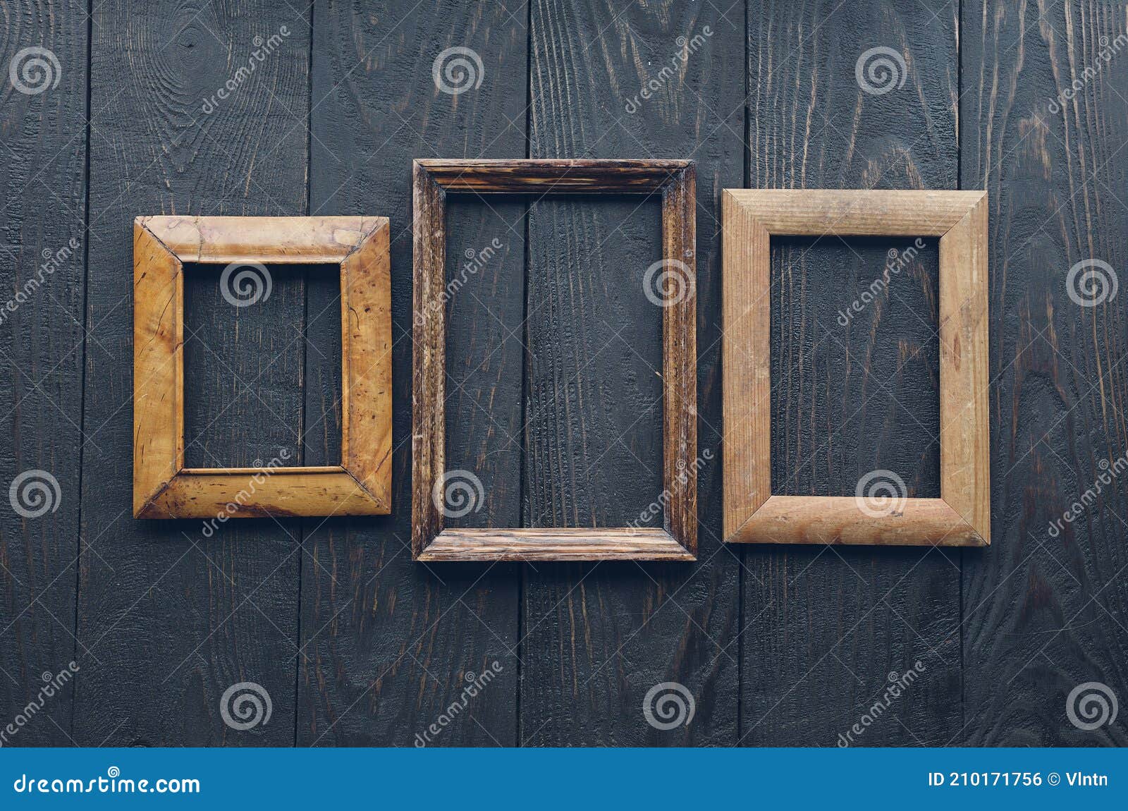Old frames on wooden wall stock photo. Image of aged 210171756