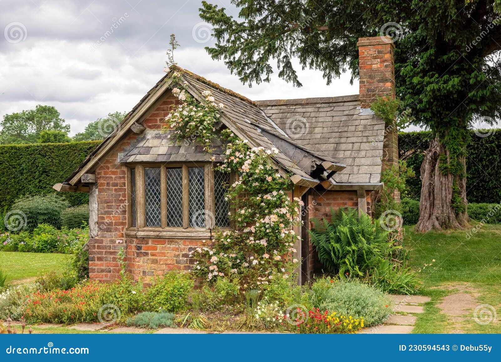 Old Garden House with Slate Roof and Climbing Rose. Stock Image Image