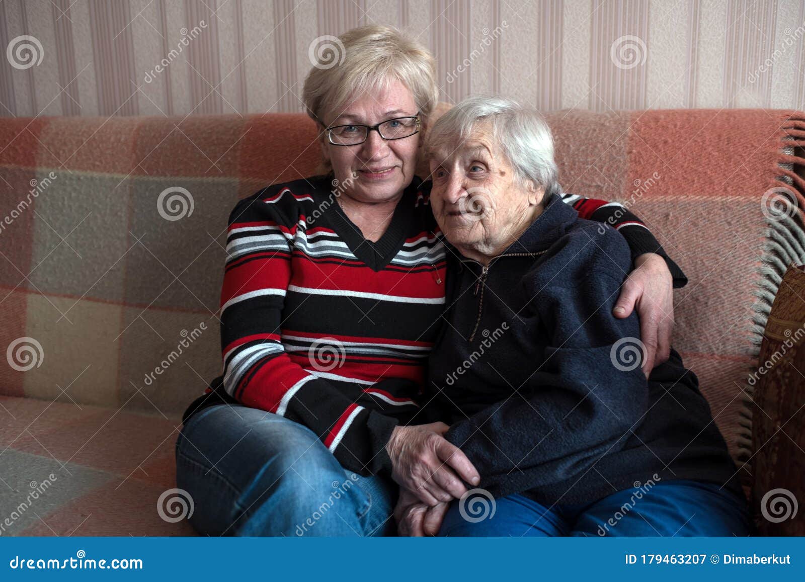 An Old Grandma Woman In An Embrace With His Adult
