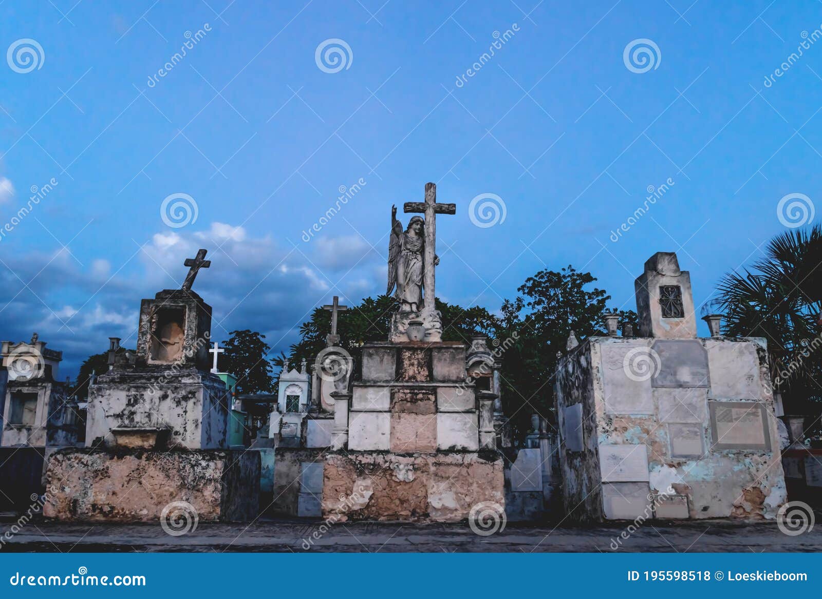 old graveyard tombs with crosses and angel statue at the cemetery `cementerio general` in merida, yucatan, mexico