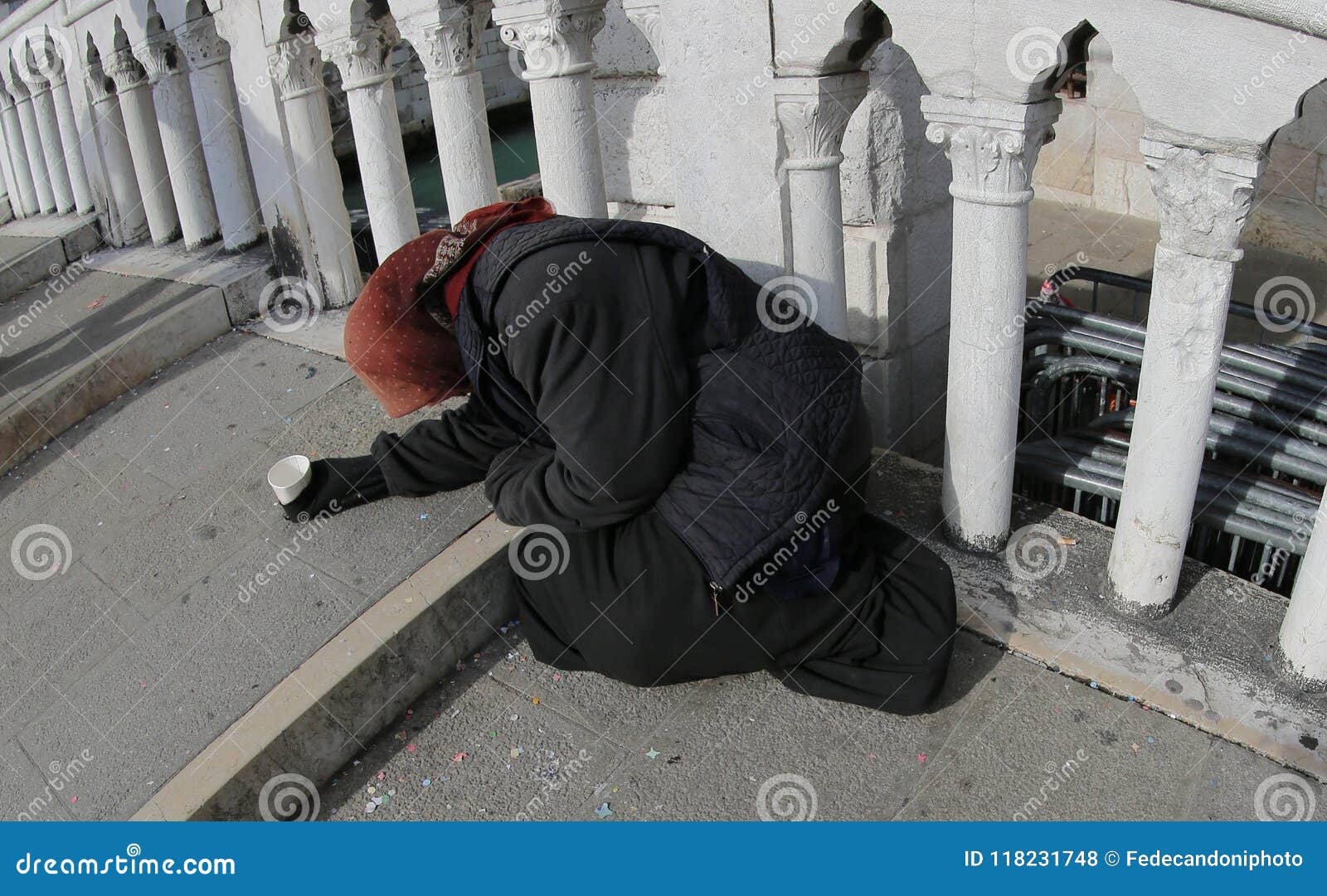 poor old gypsy asks for alms on the bridge