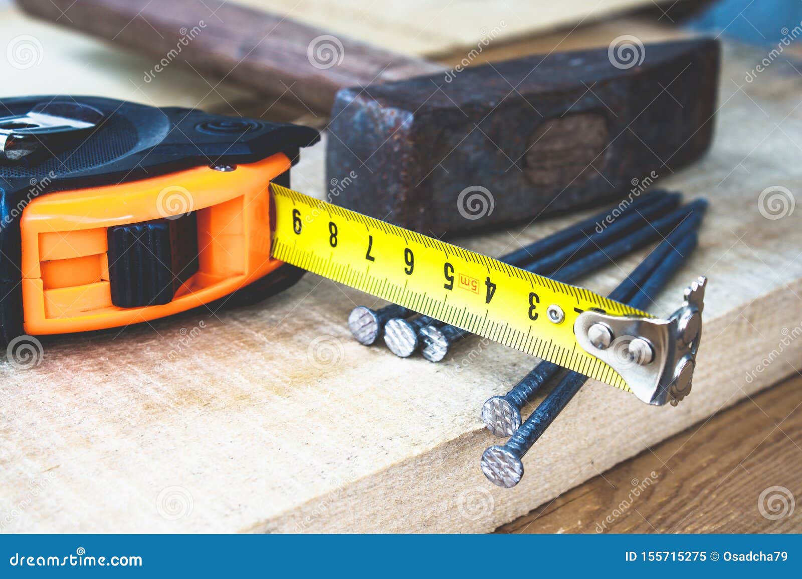 Old Hammer with Nails and a Yellow Ruler of Roulette on a Blackboard