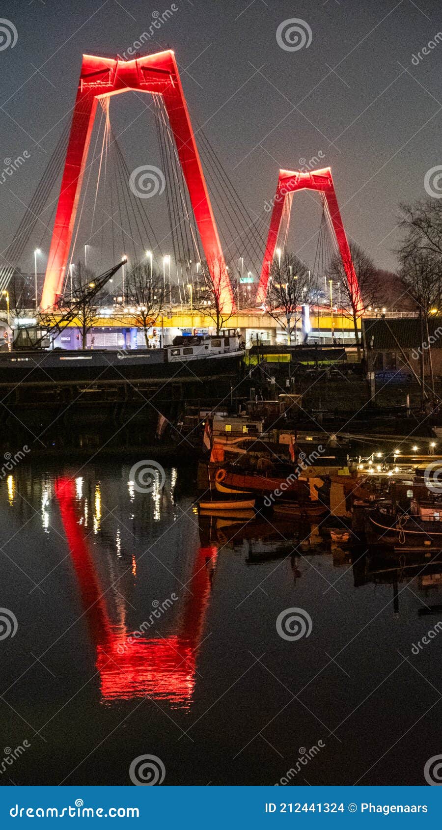 old harbour rotterdam at night with the willemsbrug reflected in the water
