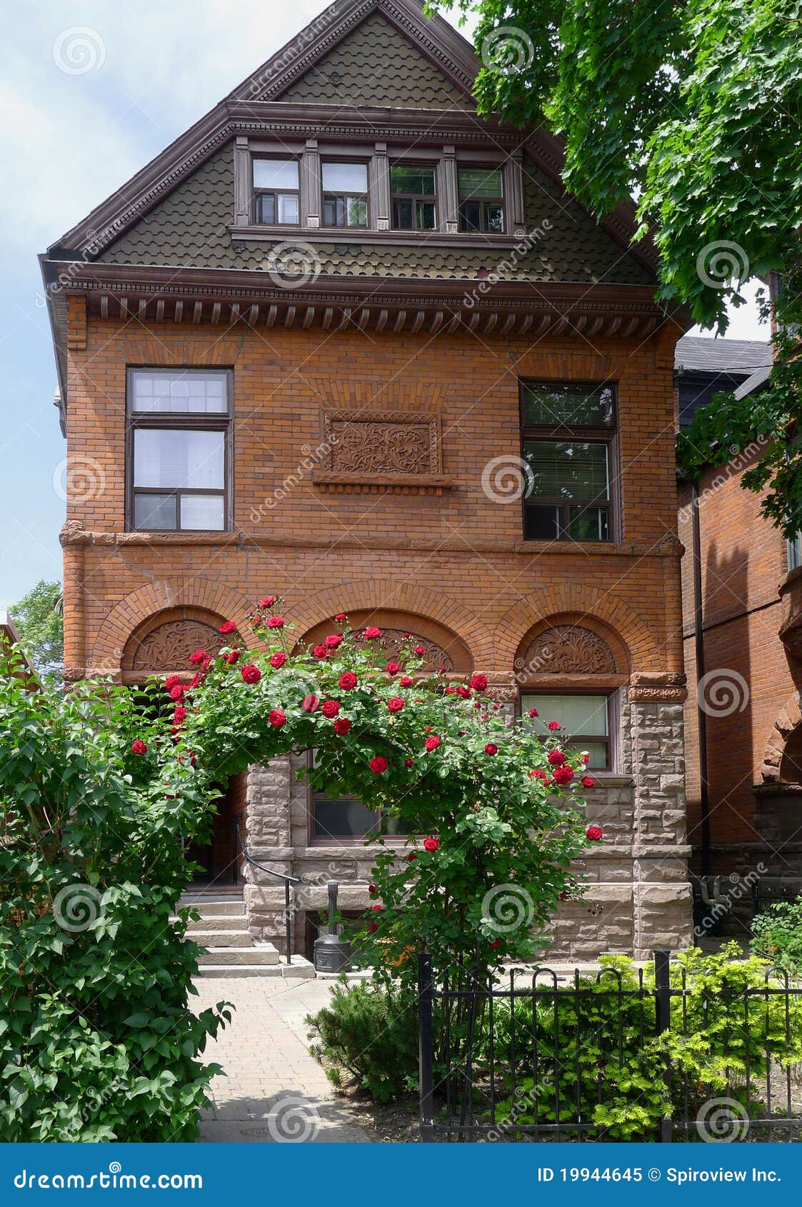Old house with rose arbor stock image. Image of arbor 19944645