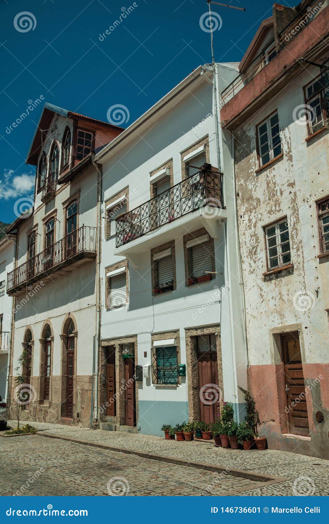 old houses with worn plaster and wooden doors