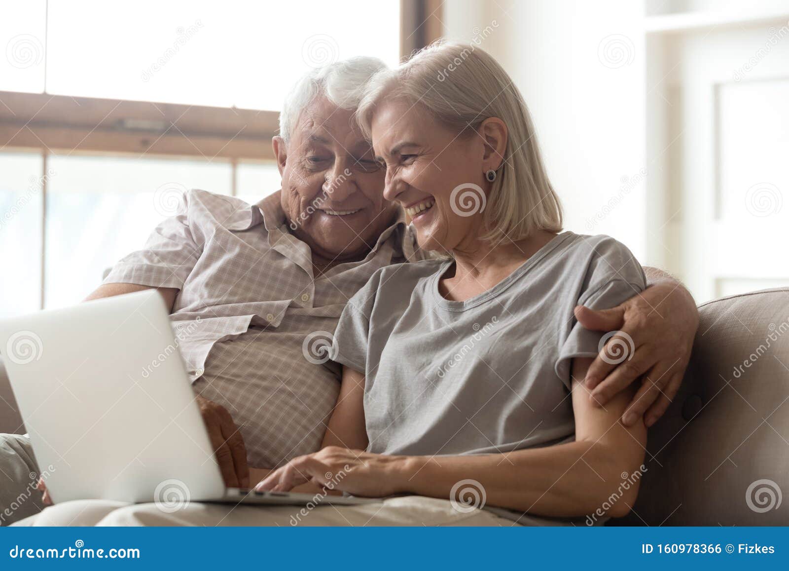 Old Husband and Wife Using Laptop Chatting with Grownup Childre