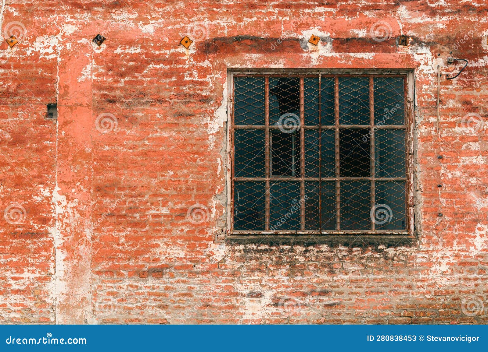 old industrial metallic grid window with mullion and muntin on ruined factory building