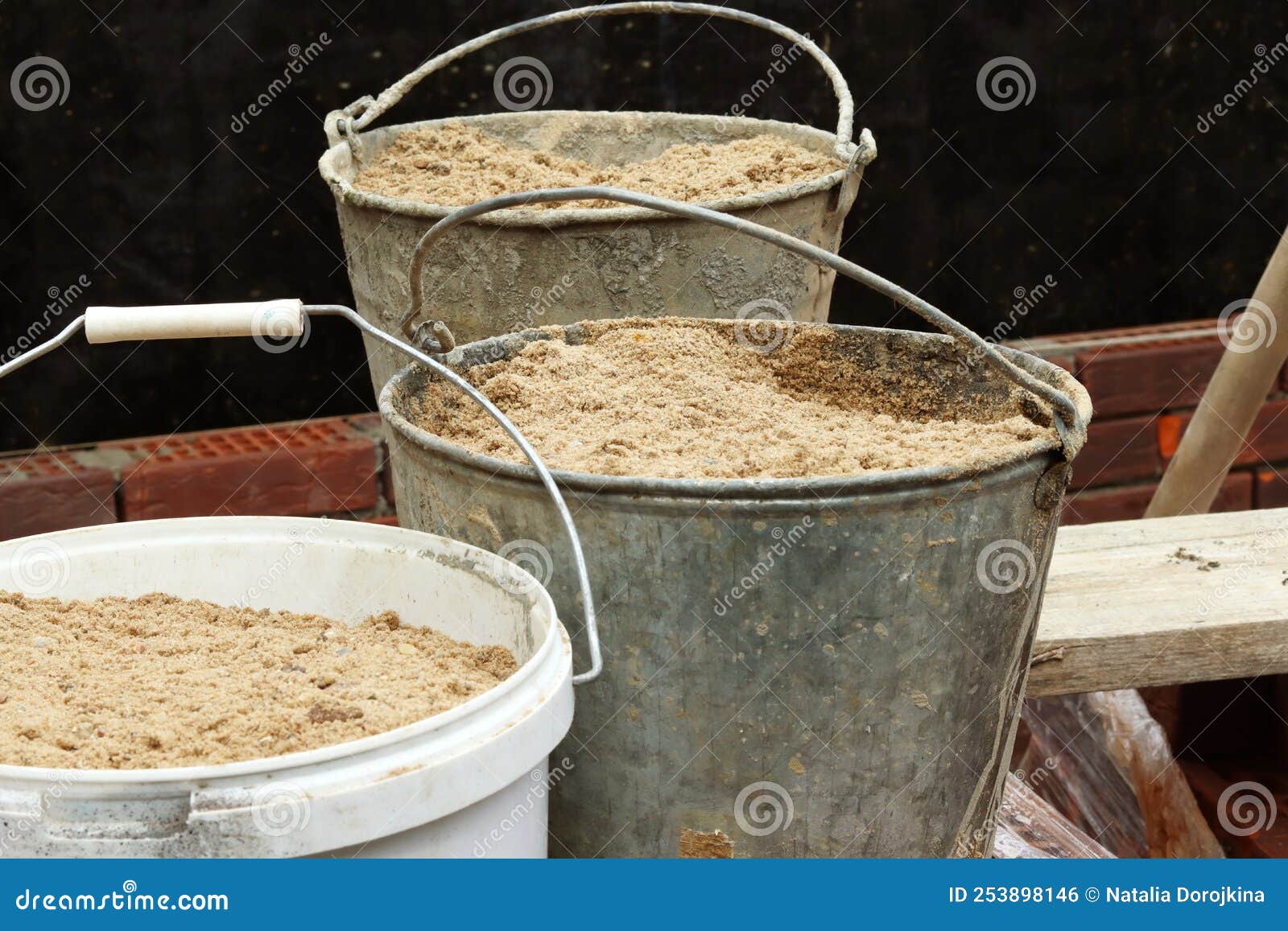 Old Iron Buckets with Sand at the Construction Site. Selective Focus