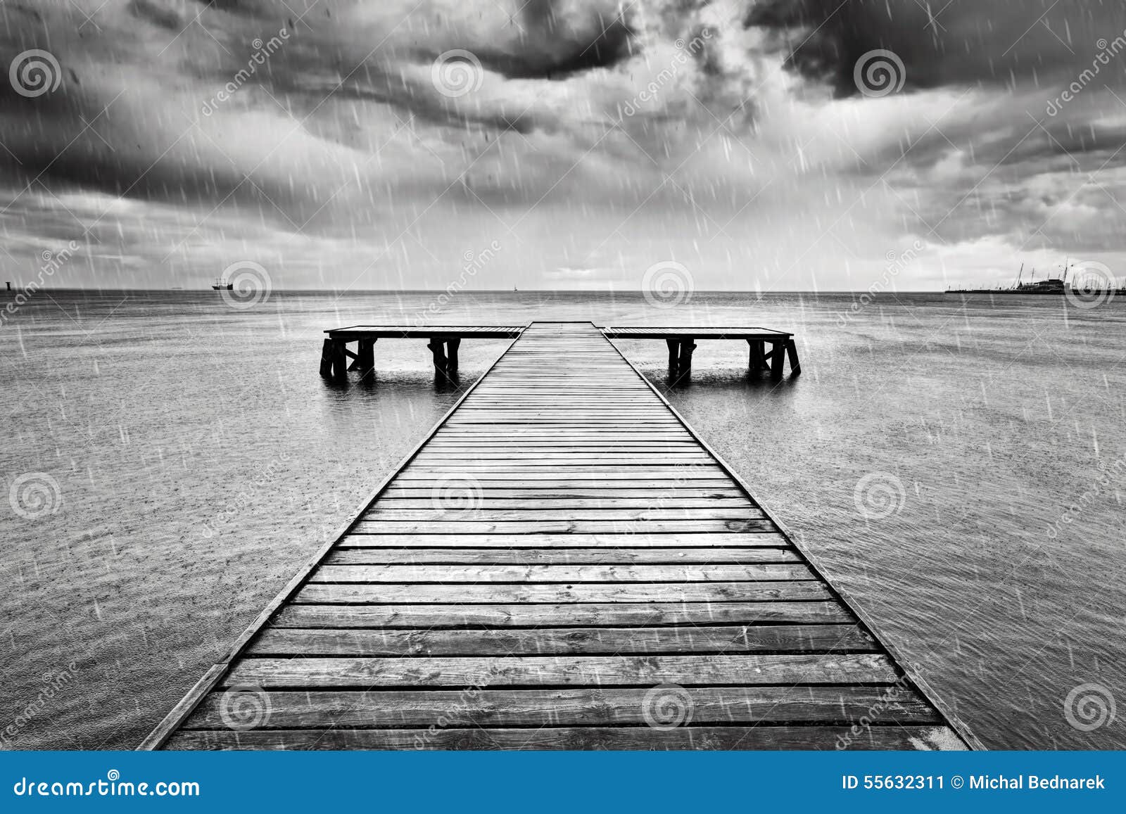 old jetty, pier on the sea. black and white, rain.