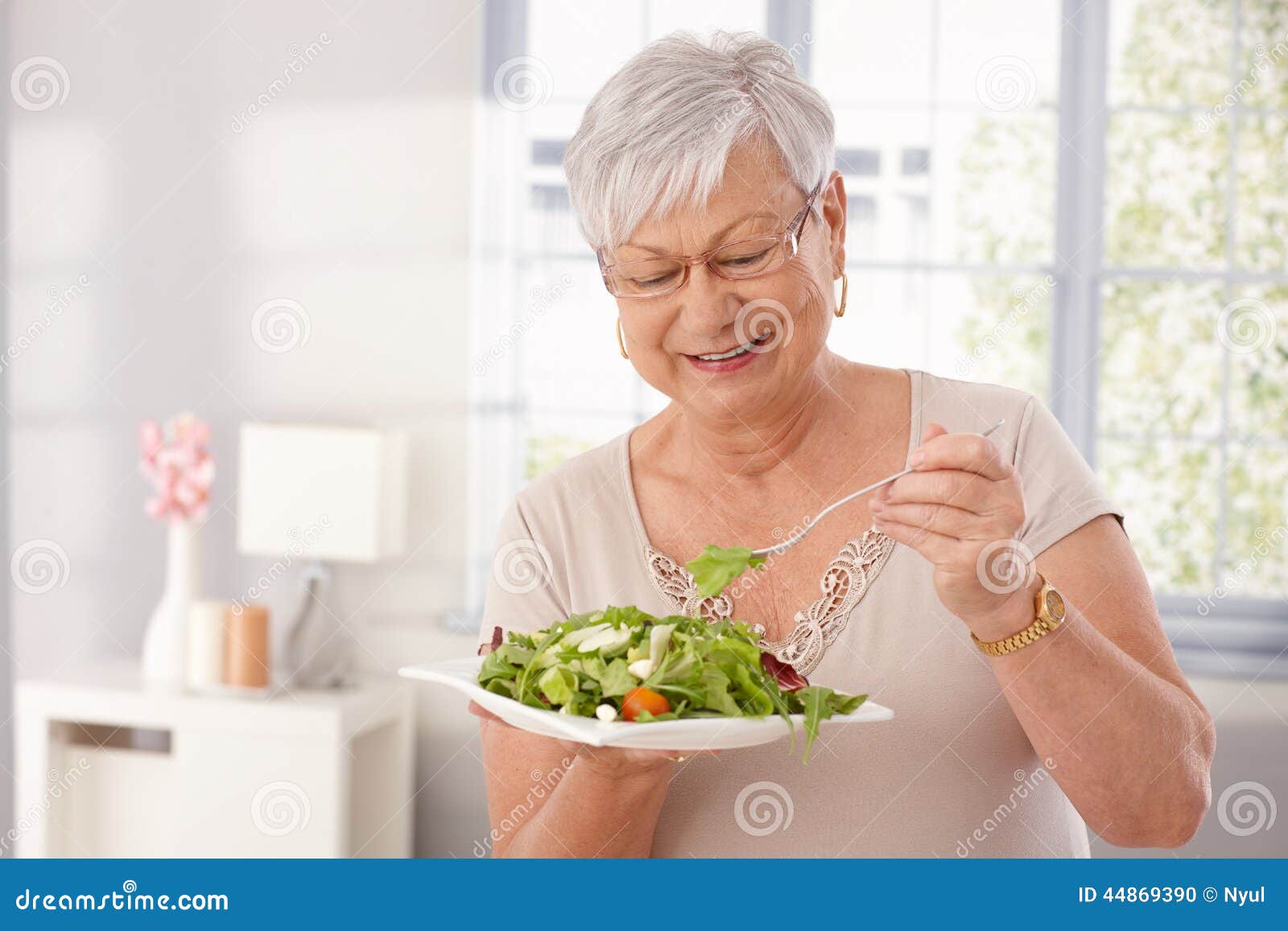 old lady eating green salad