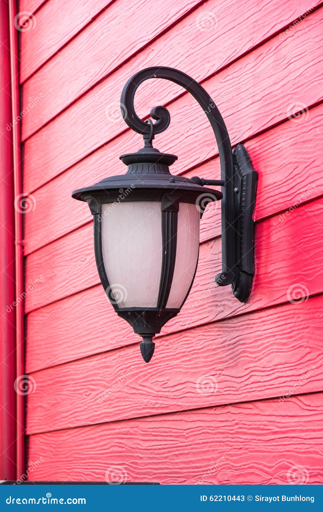 Old lamp on red wood wall stock image. Image of cracked 62210443