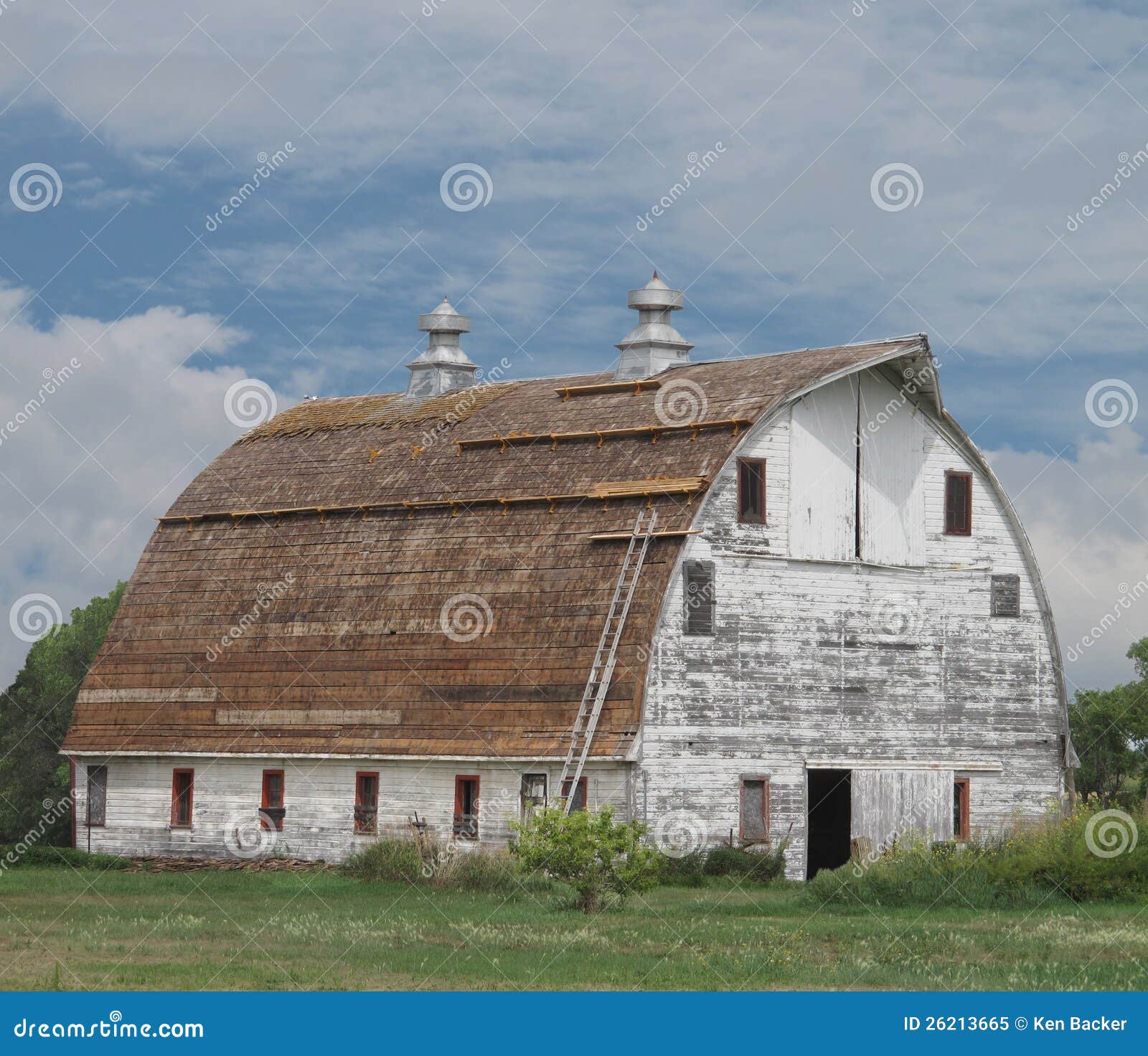 Old Large White Wooden Barn With Curved Roof. Royalty Free 