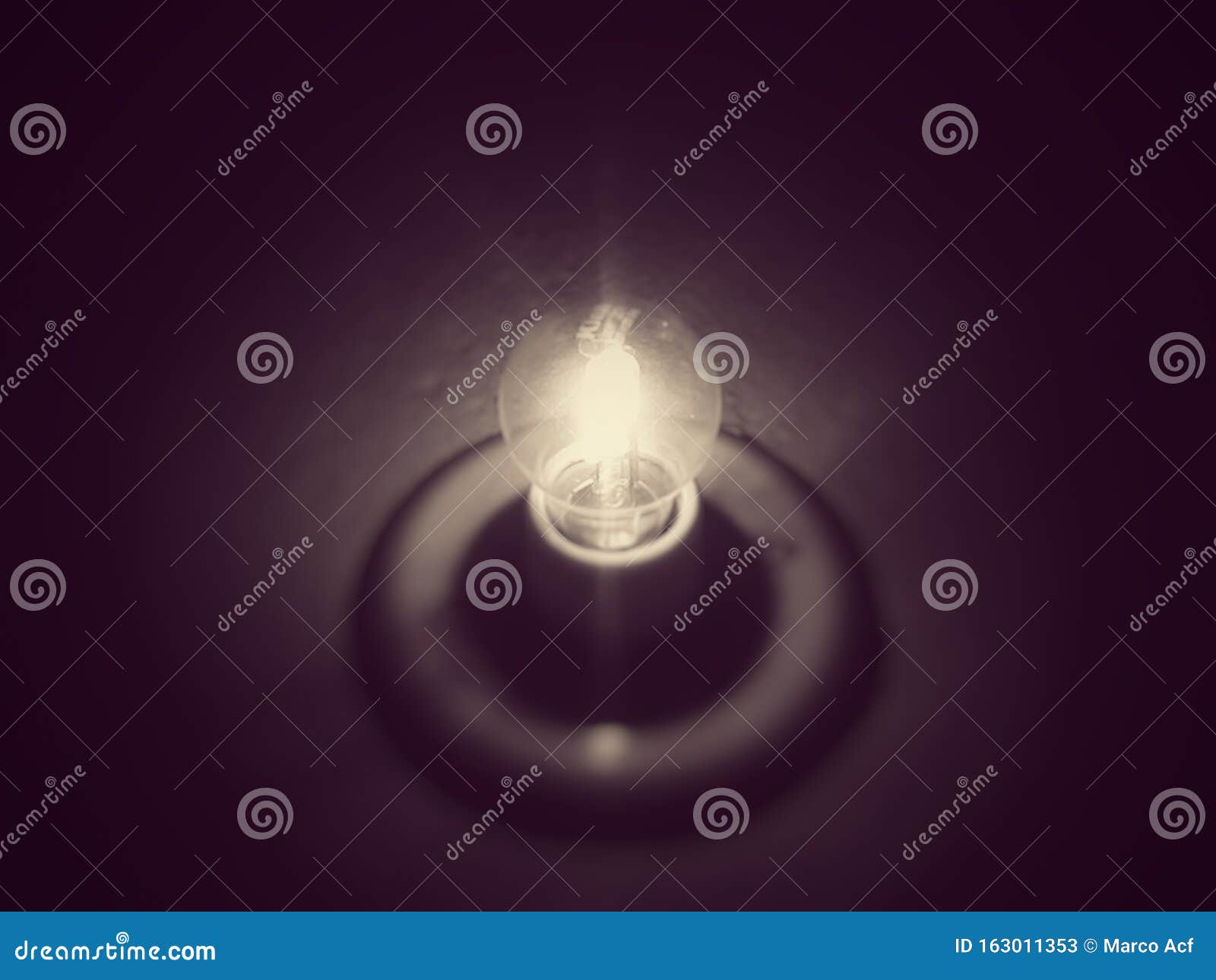 old light bulb on dark background, illuminating the darkness