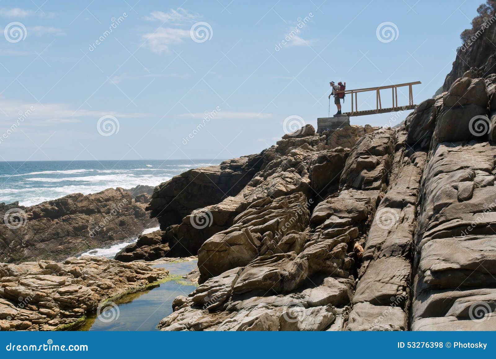 old male backpacker looks at sea