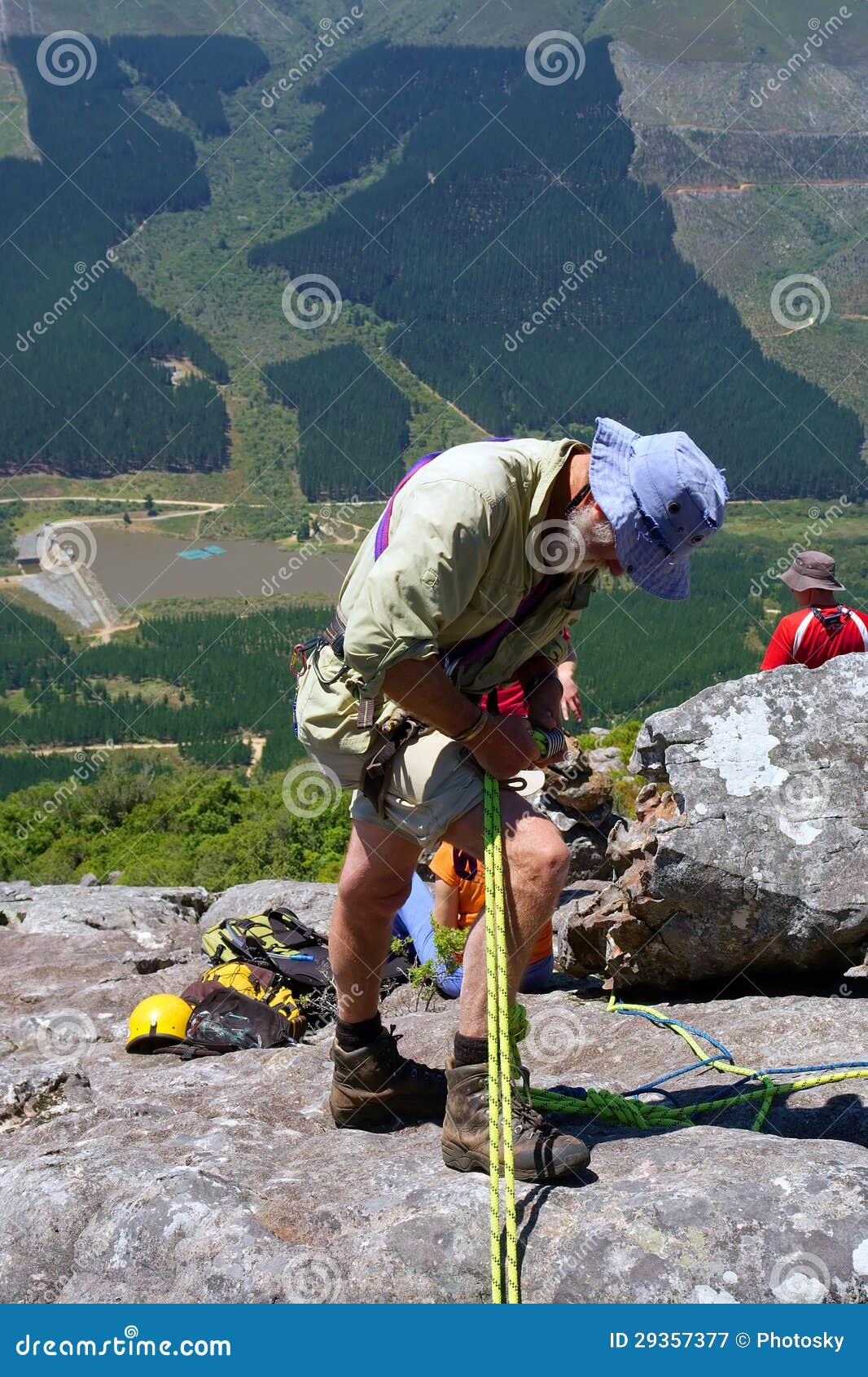 old man adjust gear for rope climbing