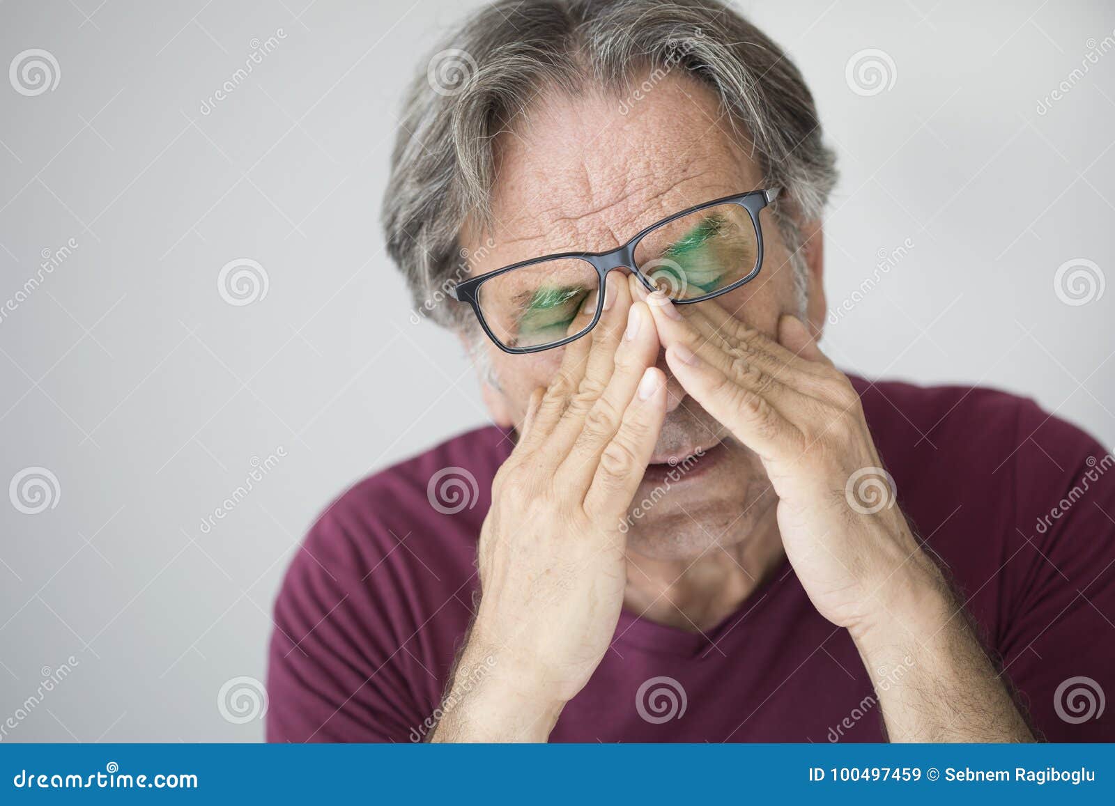 old man with eye fatigue