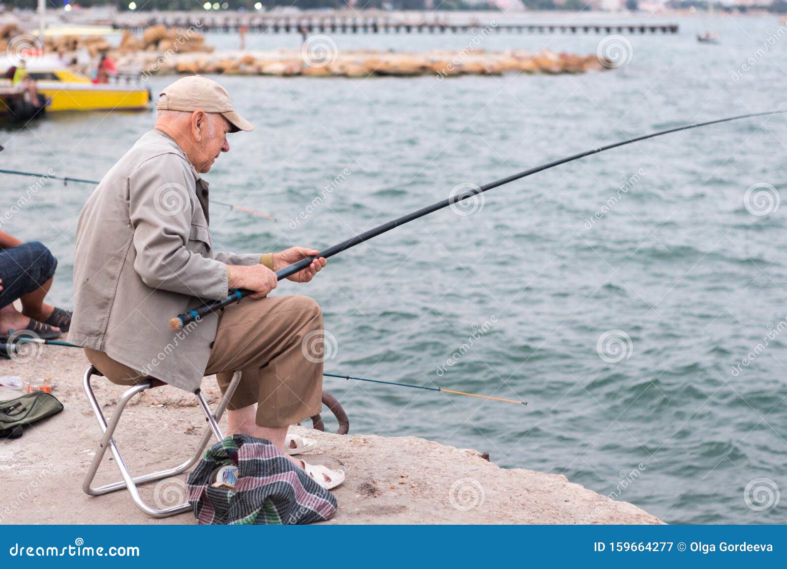 Old Man Fishing on a Fishing Rod in the Sea, in the Evening Stock Image -  Image of minimalism, calm: 159664277