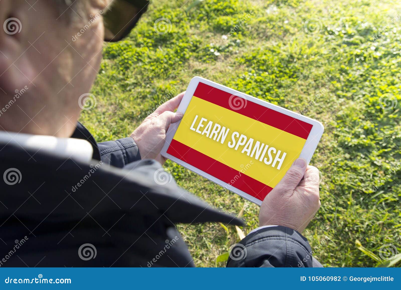 Old man holding tablet with learn spanish app stock photo image of