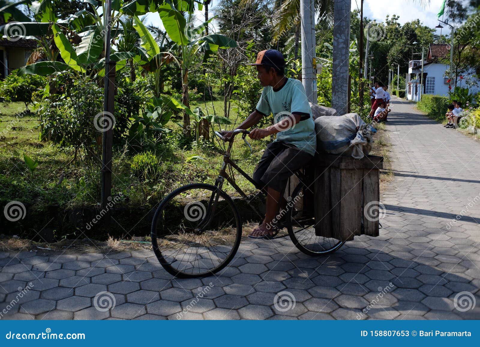 Download An Old Man Rides His Old Bicycle That Has Been Modified To ...