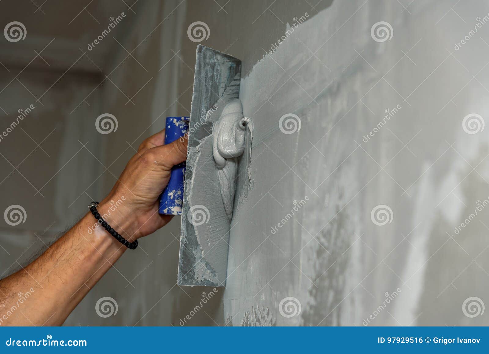 old manual worker with wall plastering tools renovating house