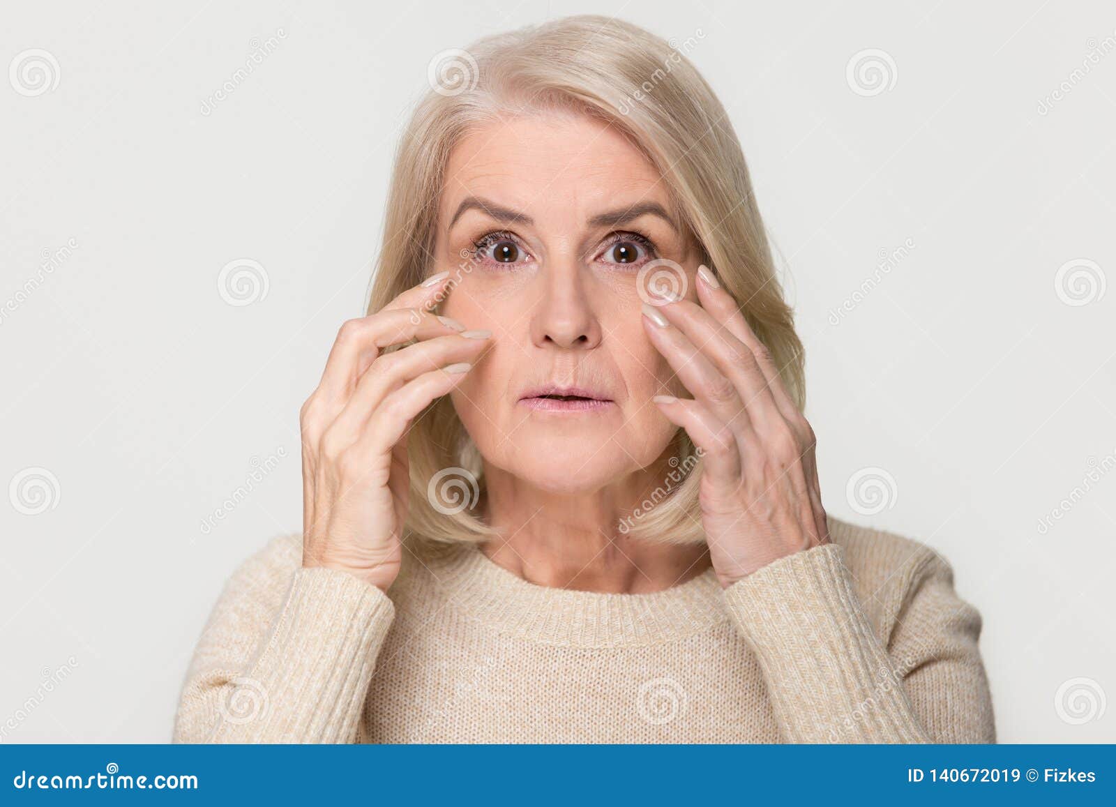 old mature woman looking at camera worried about face wrinkles
