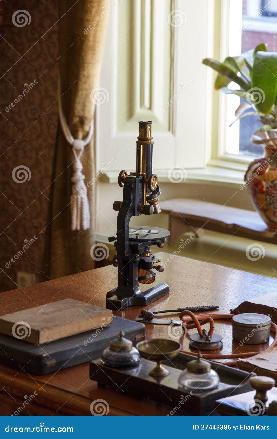 old microscope on the desk of the doctor