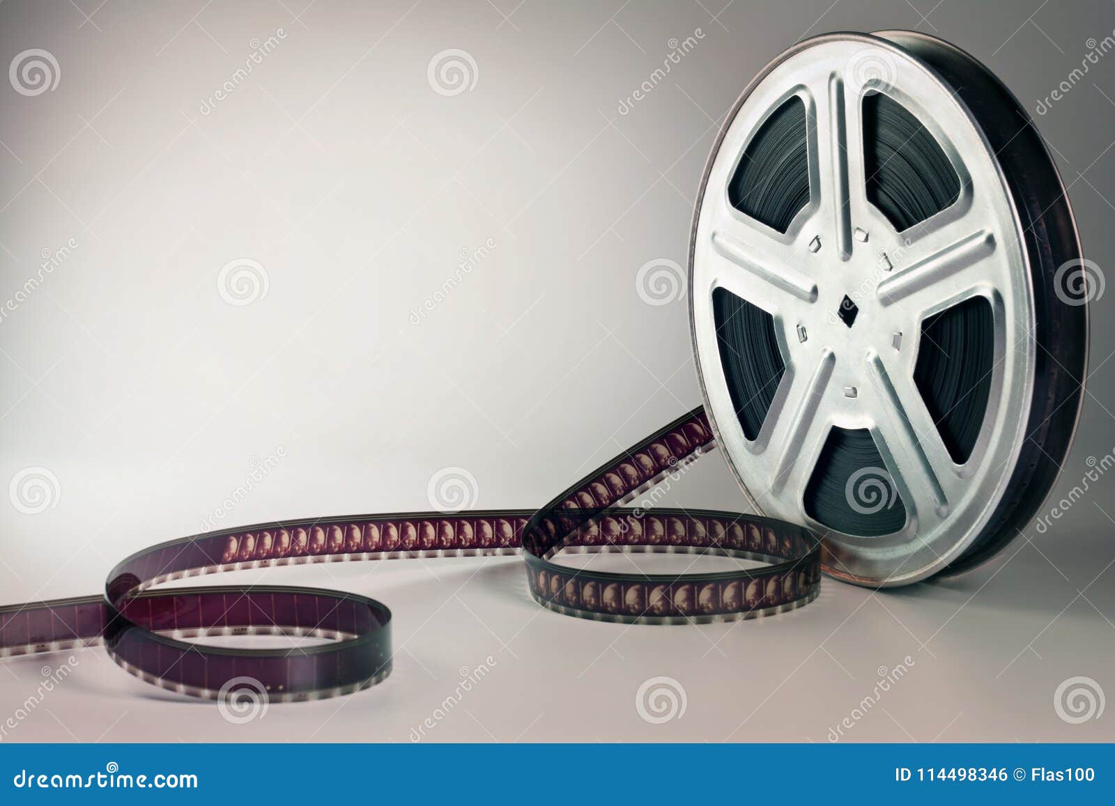 Old Motion Picture Film Reel on Brown Background Stock Photo