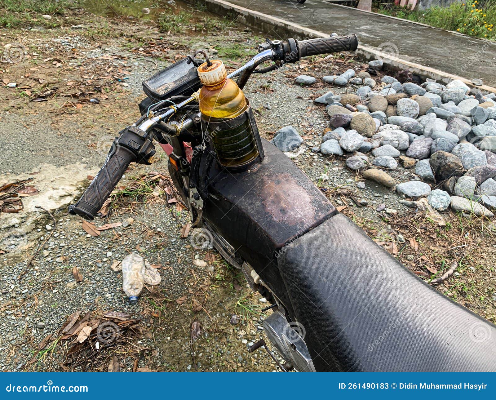 An Old Motorbike with a Modified Gas Tank Using an Old Bottle Stock