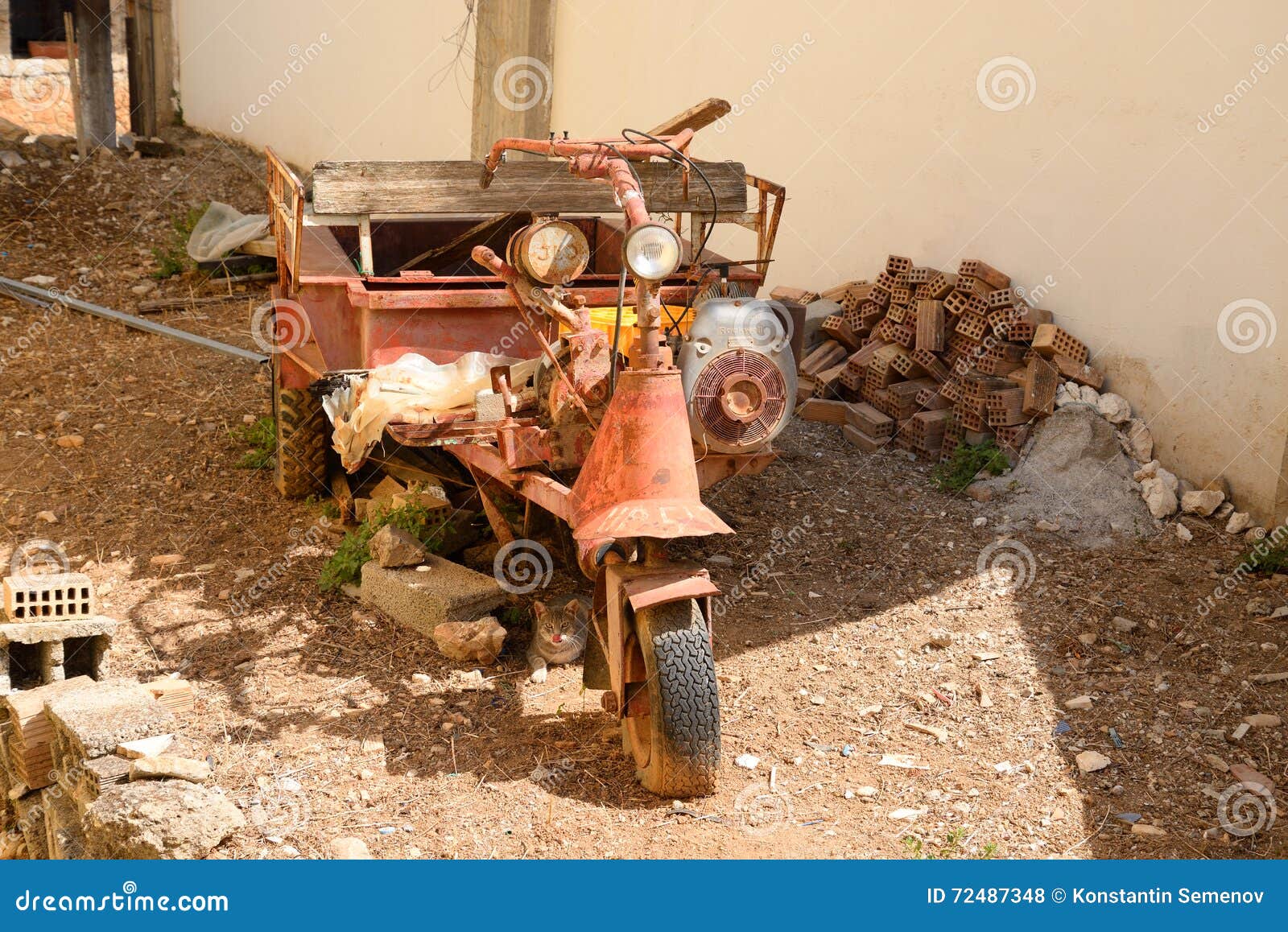 Rusty Motorcycle Frames Near Wooden Building Of Abandoned Primary