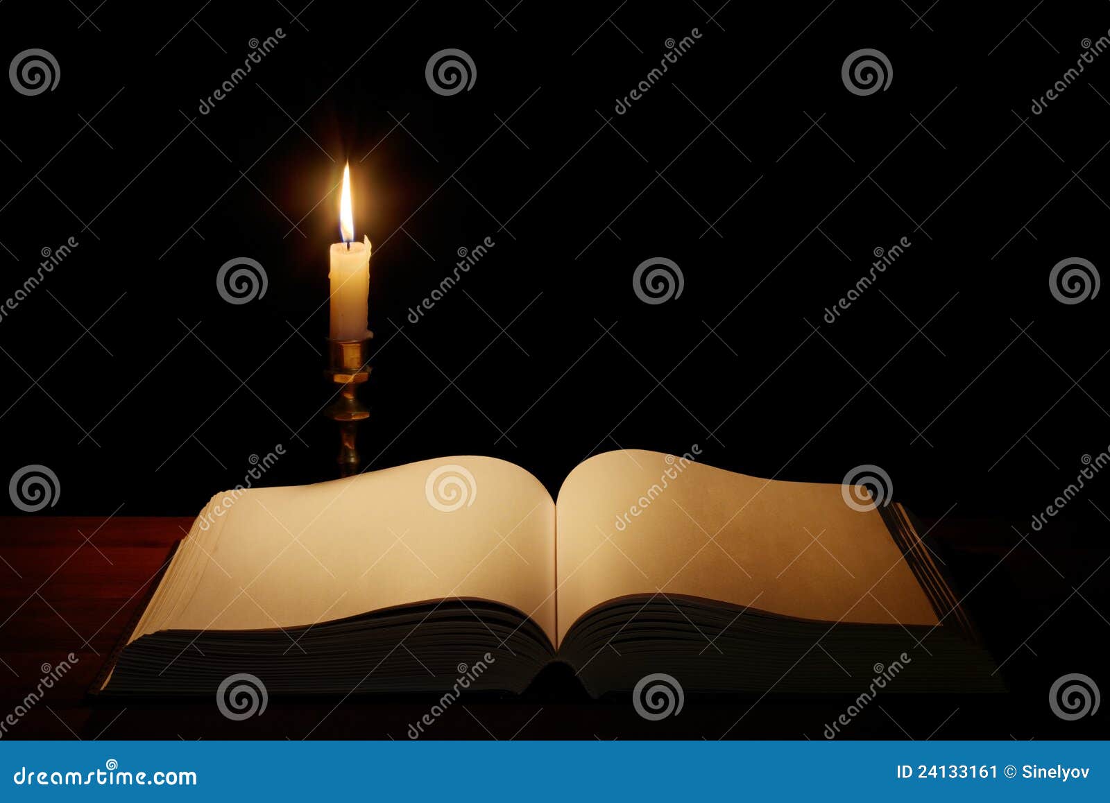 old open book with candle