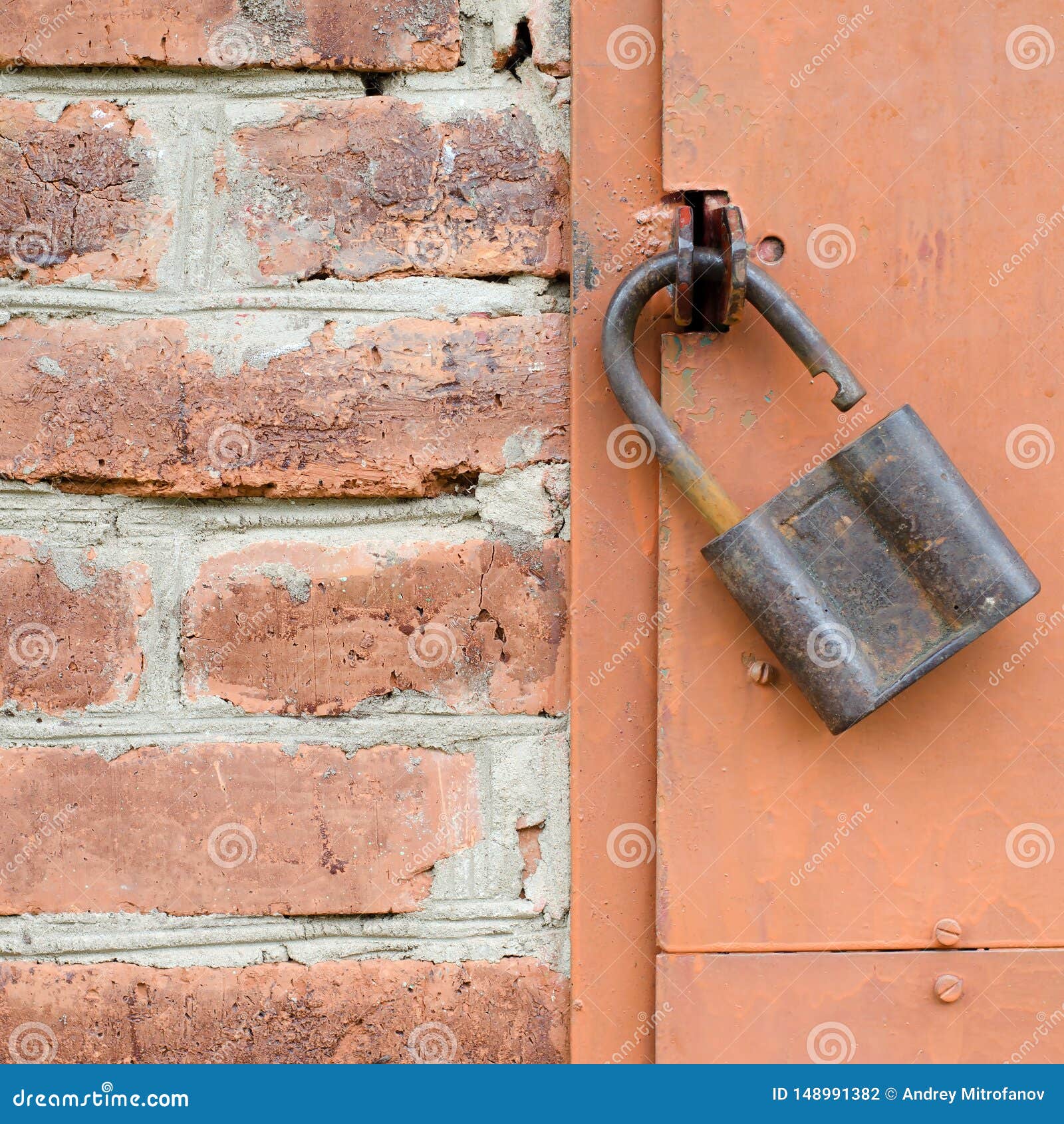 Old Padlock on Metal Door. Red Brick Wall Stock Photo - Image of ...