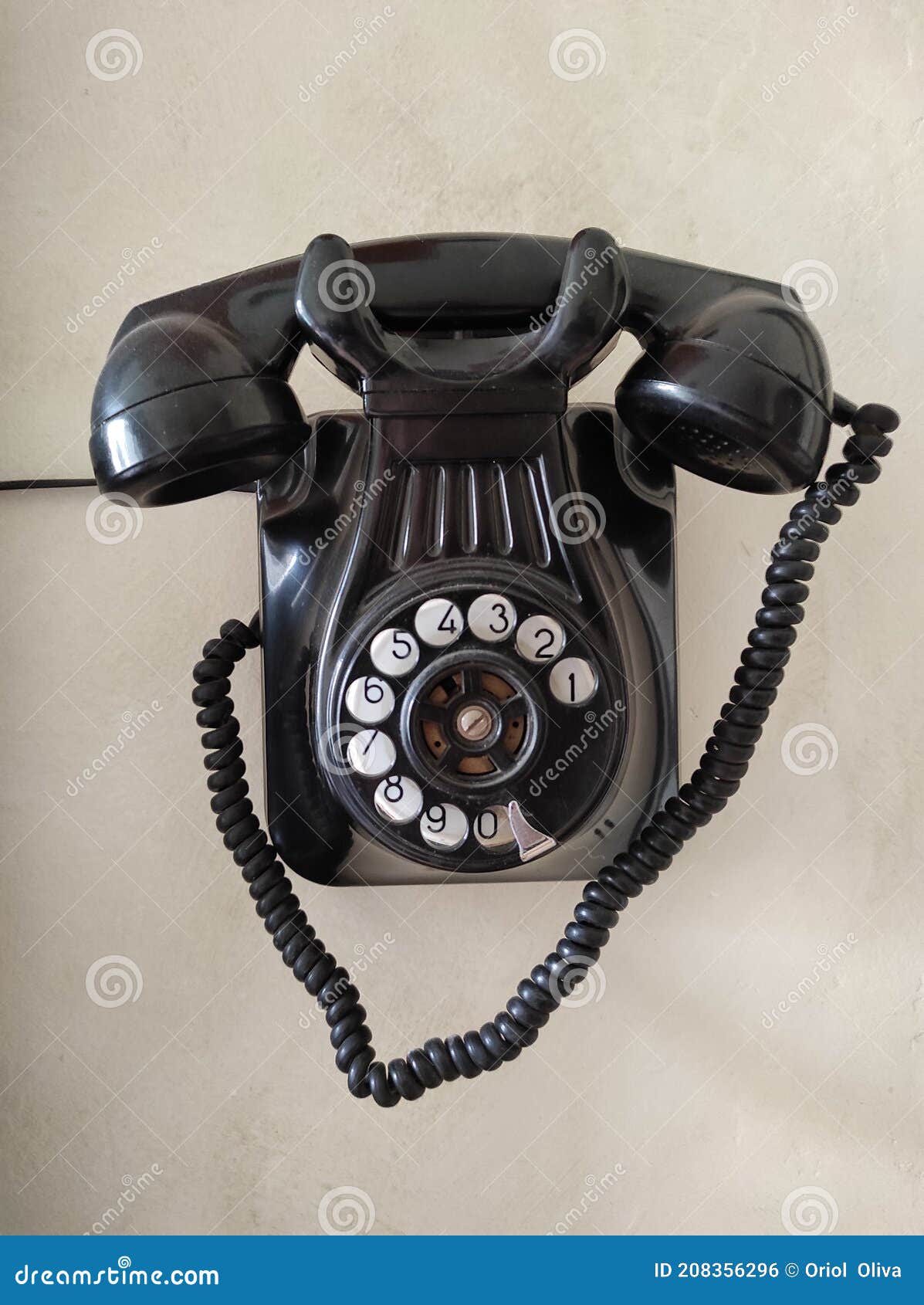 old phone hanging on the wall. black color. vintage