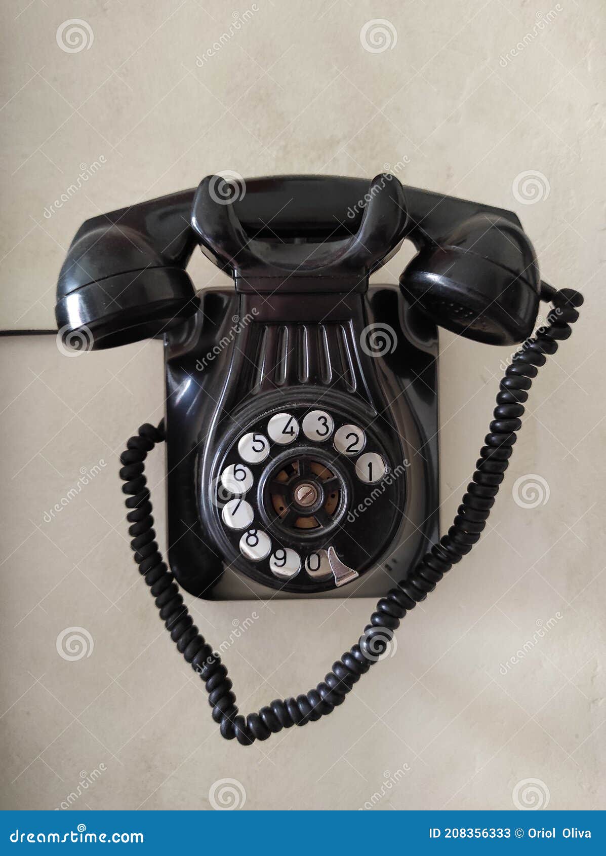 old phone hanging on the wall. black color. vintage