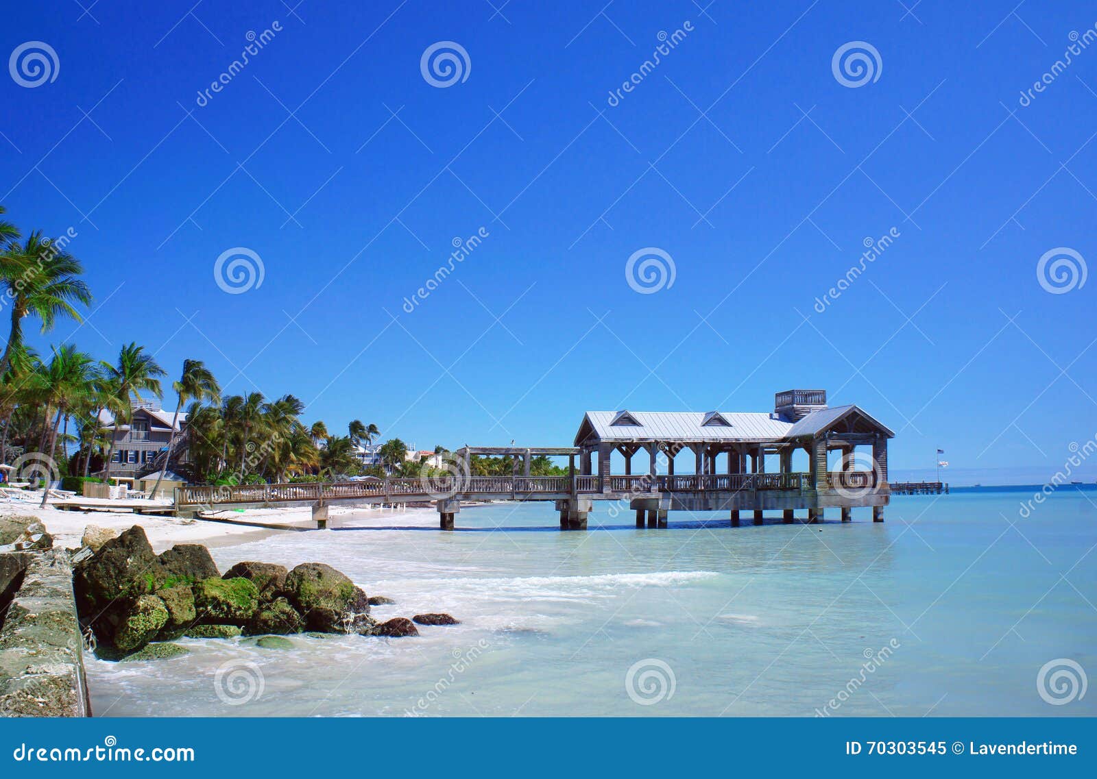 Florida Keys Tiny Beach Rimmed With Coconuts With Dock And Kayaks And