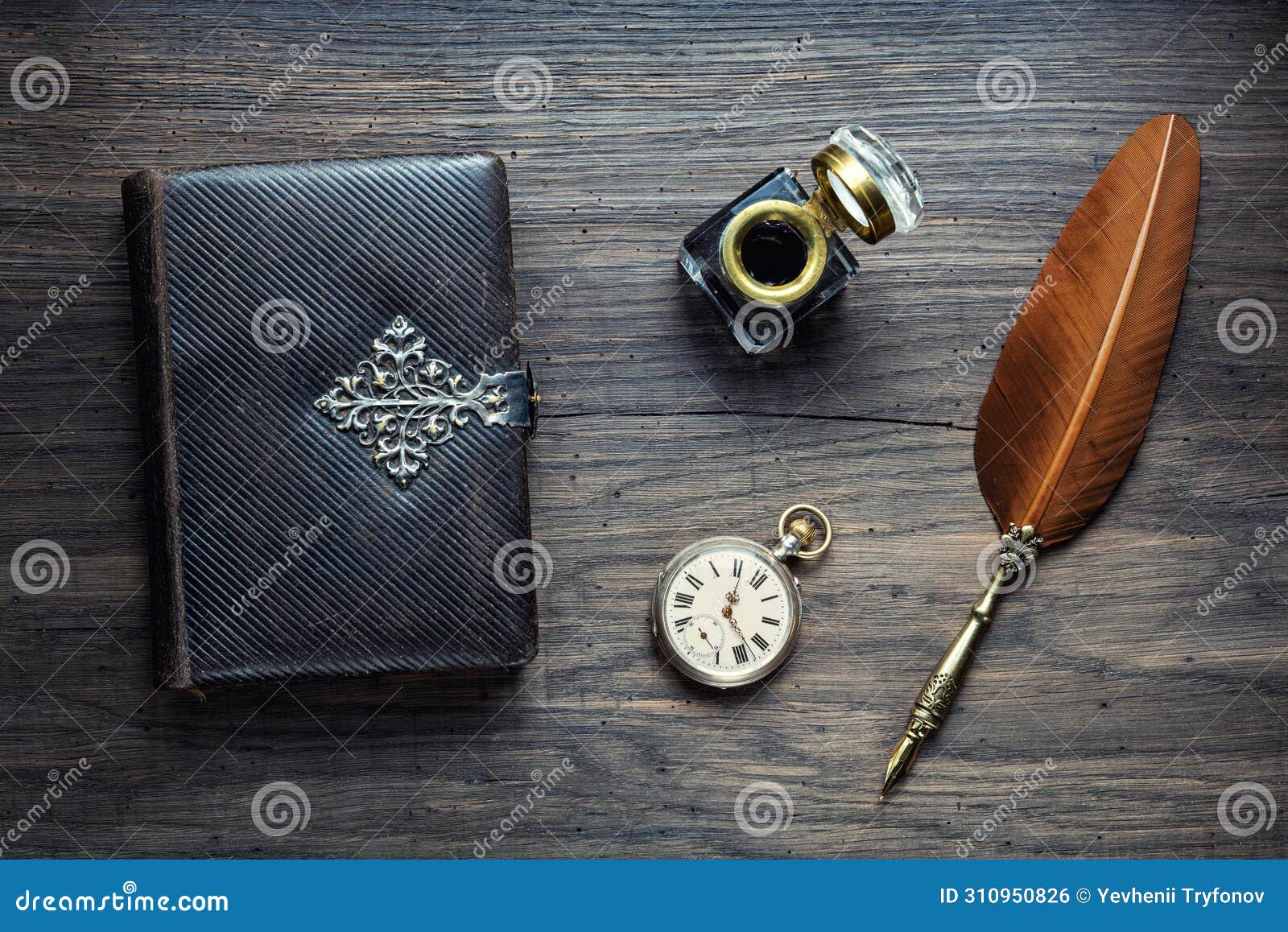 old quill pen, old book, clock and vintage inkwell on wooden desk in the old office . retro style. conceptual background on