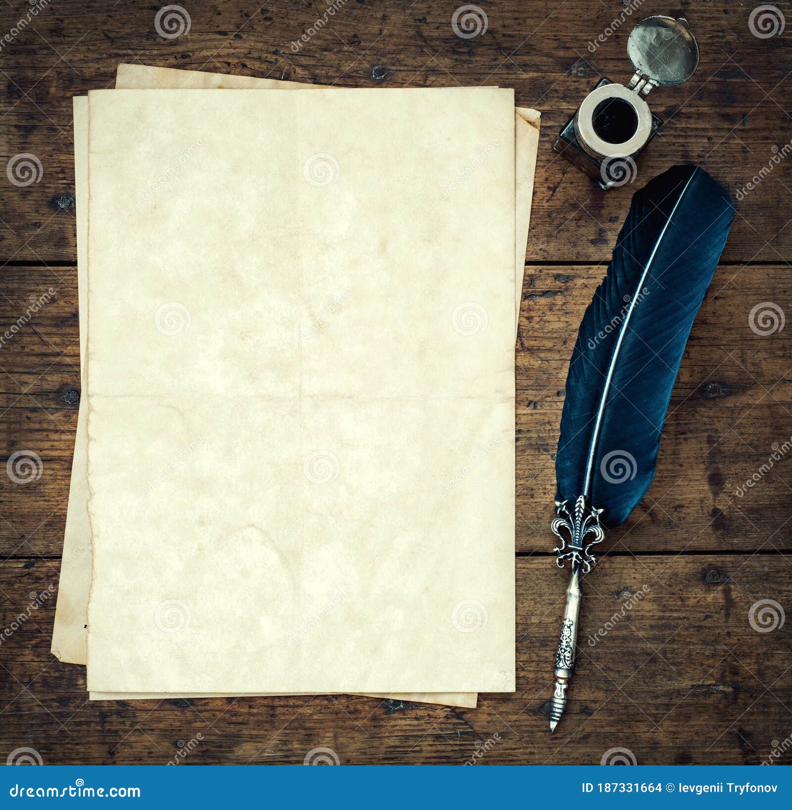 old quill pen, and old paper blank sheet and vintage inkwell on wooden desk in the old office . retro style. conceptual background