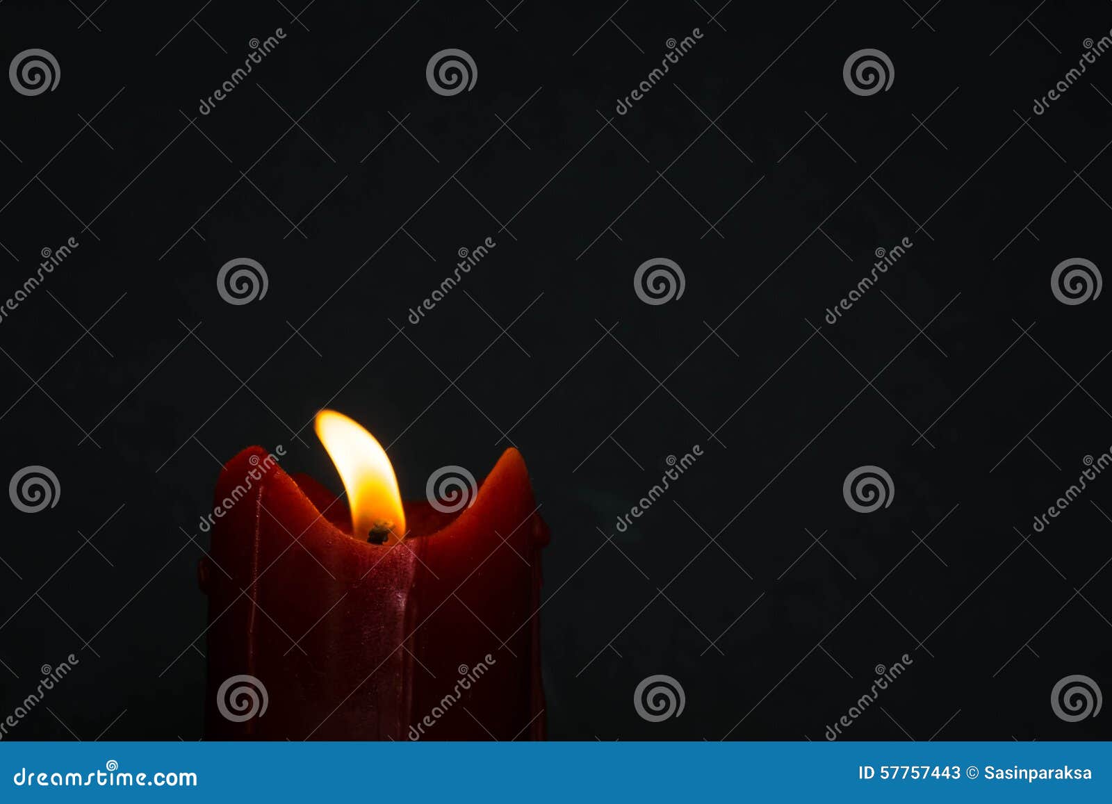 old red candle with glimmer light flame on nice grey background, with blank upper space