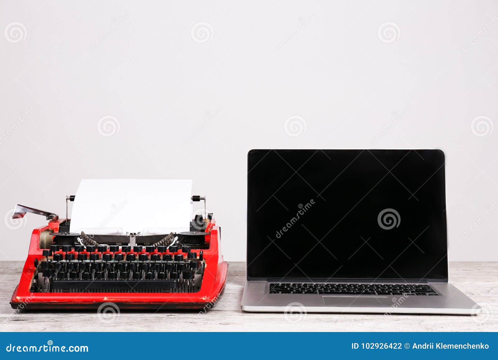 Old Typewriter and Laptop on Table. Concept of Technology Progress
