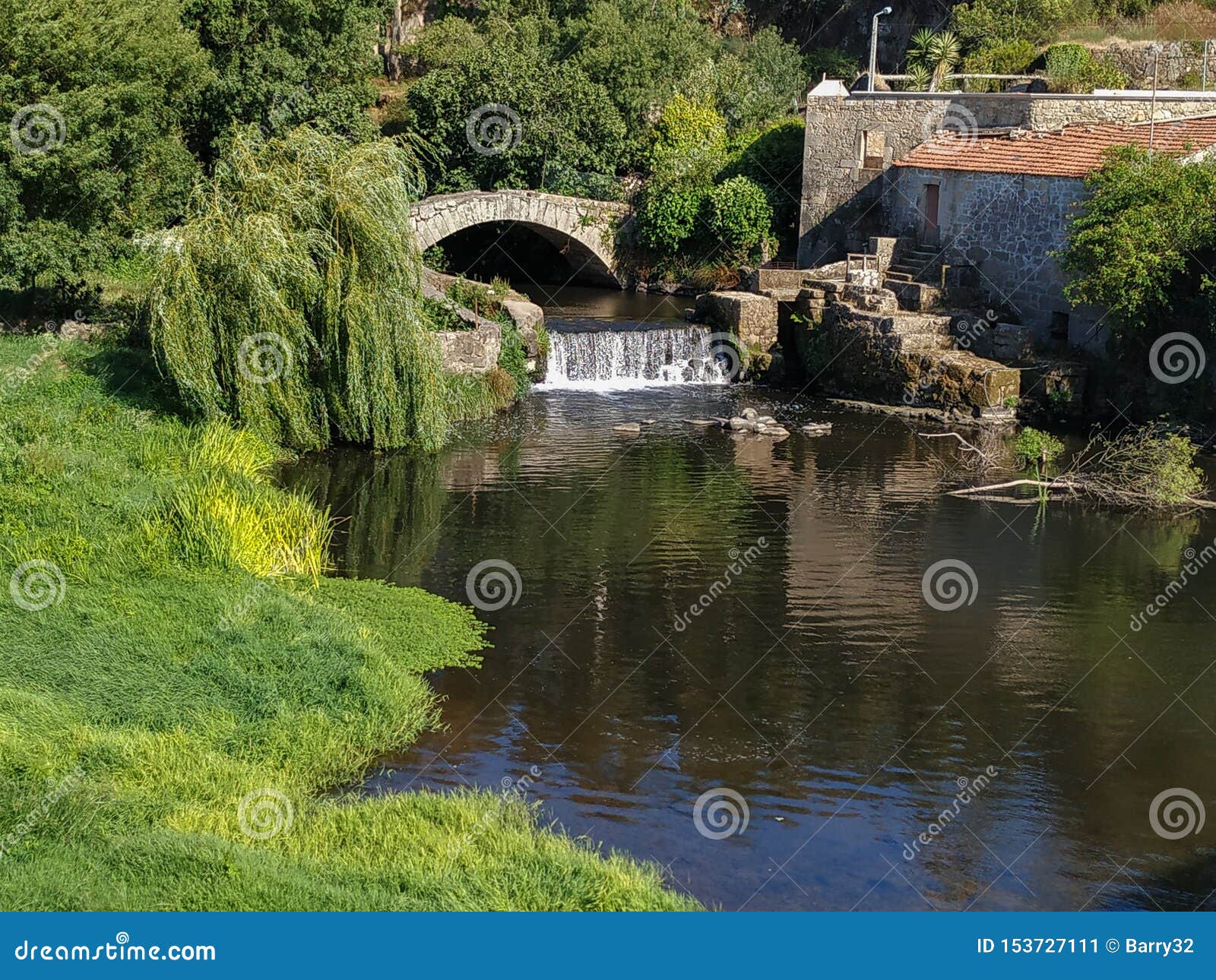 old roman stone bridge and waterfall on este river in vila do conde, portugal