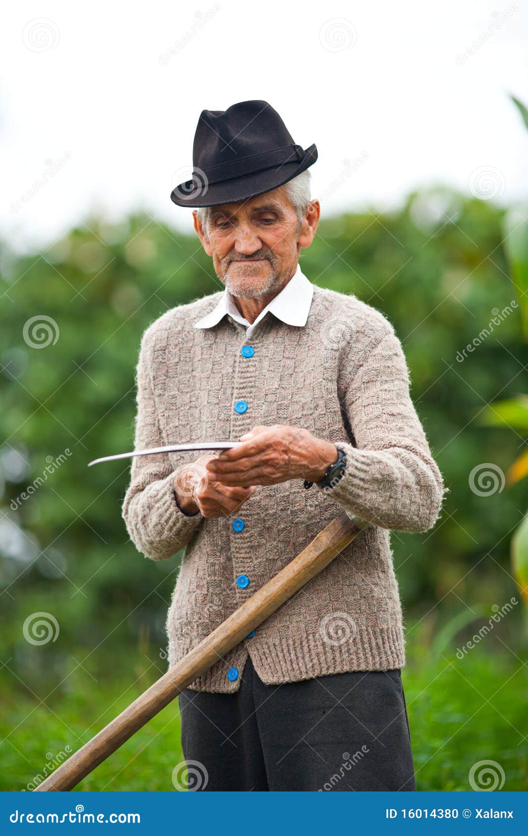 Old rural man using scythe stock photo. Image of gardening 16014380