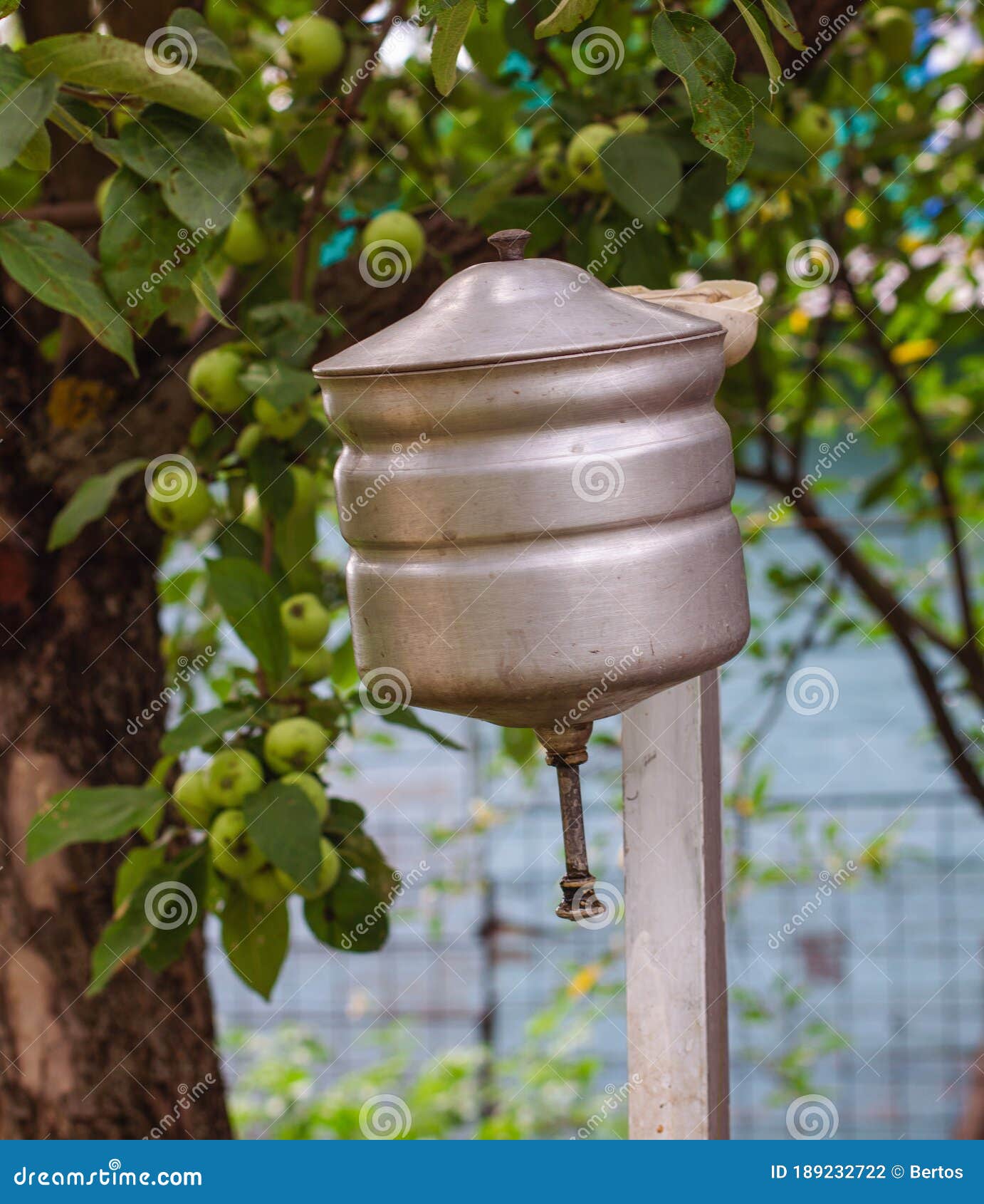 an old russian metal washstand in summer apple garden