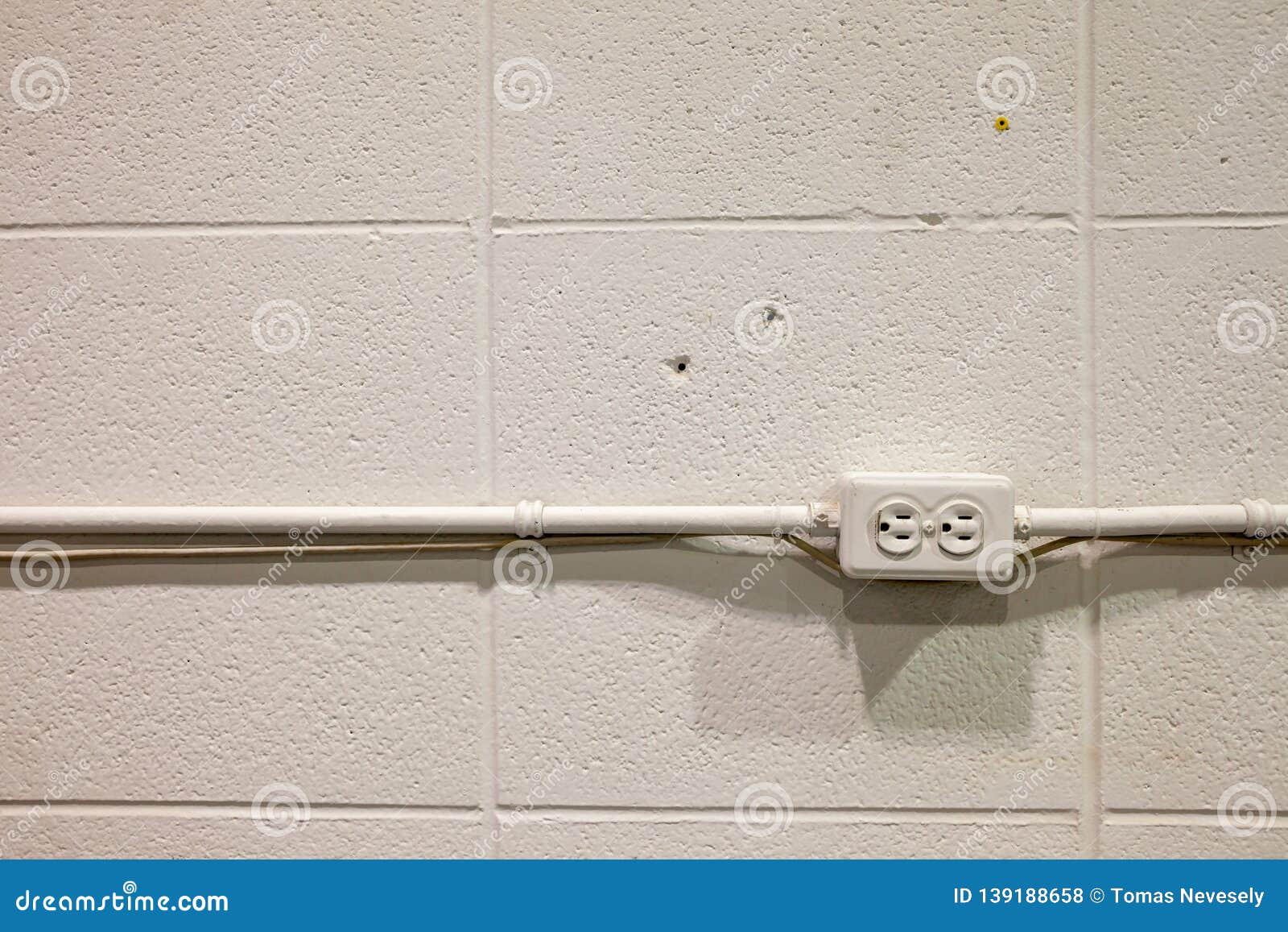 Old Rustic North American Electrical Outlet on a Brick Wall Stock Photo