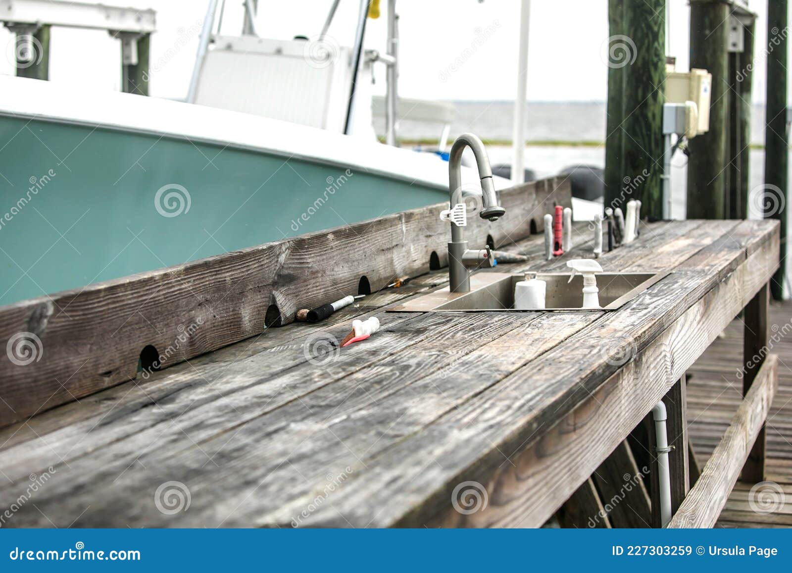 An Old Rustic and Worn Wood Fish Cleaning Station on the Dock of a