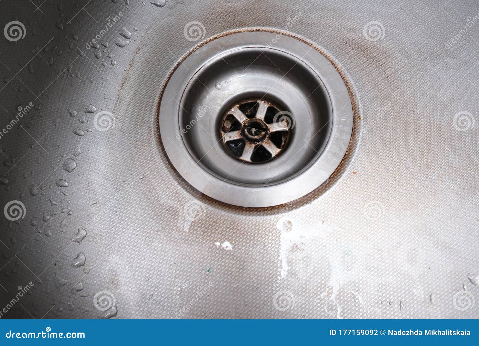 old rusty calcified drain hole in the kitchen sink with limescale and scurf scum, kitchen and house cleaning