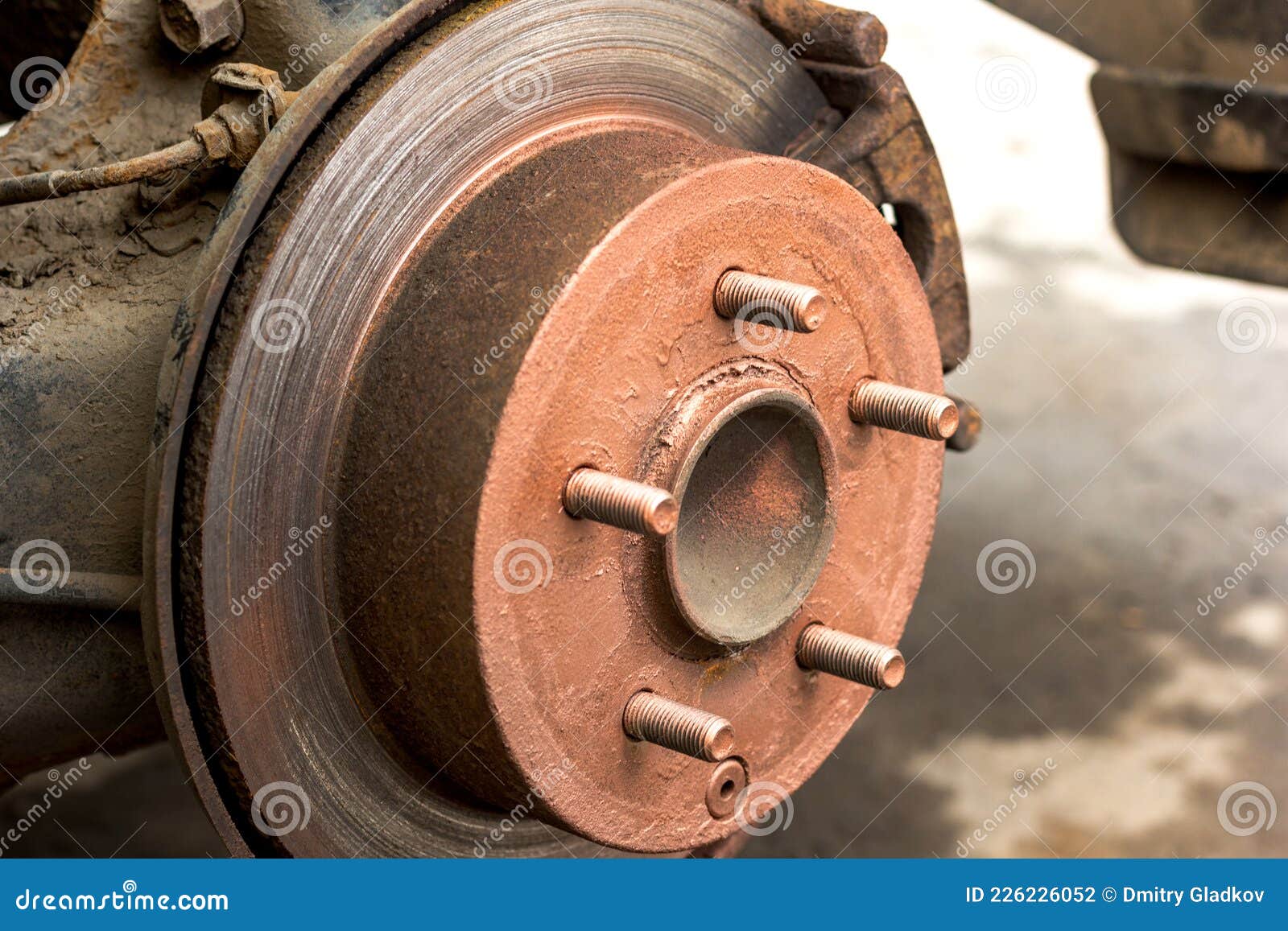 An Old Rusty Hub without a Wheel. Brake Disc and Brake Caliper on the