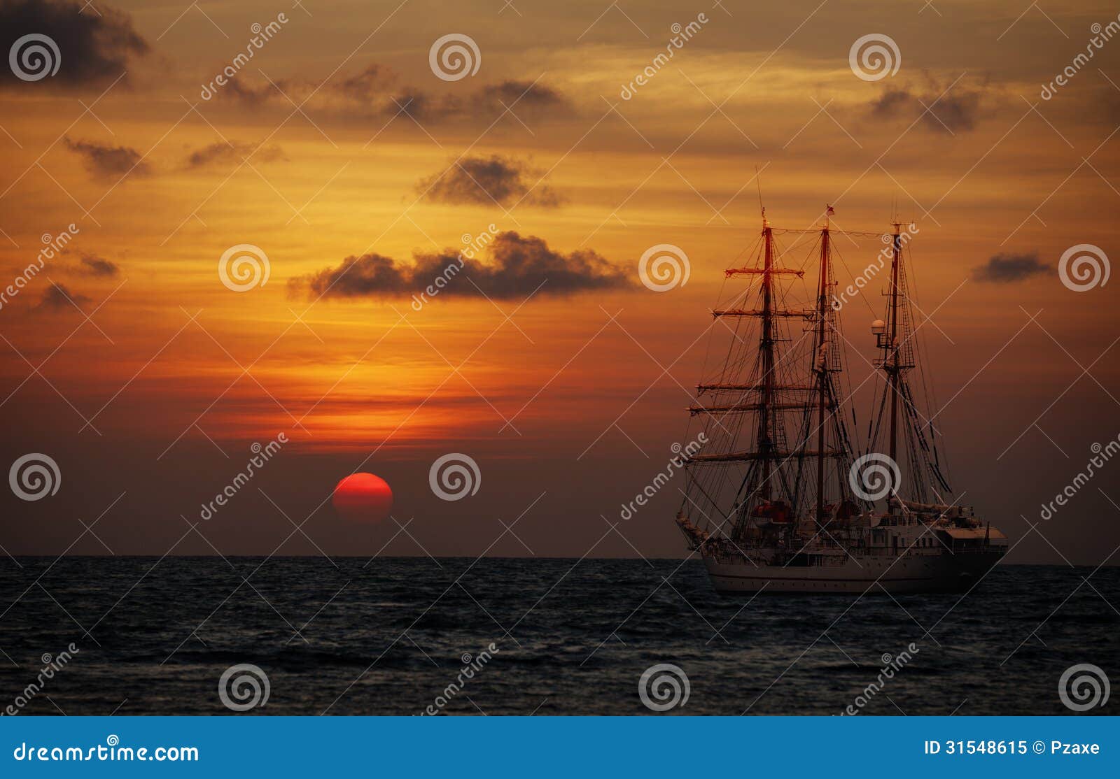 old sailing ship in the sea at sunset