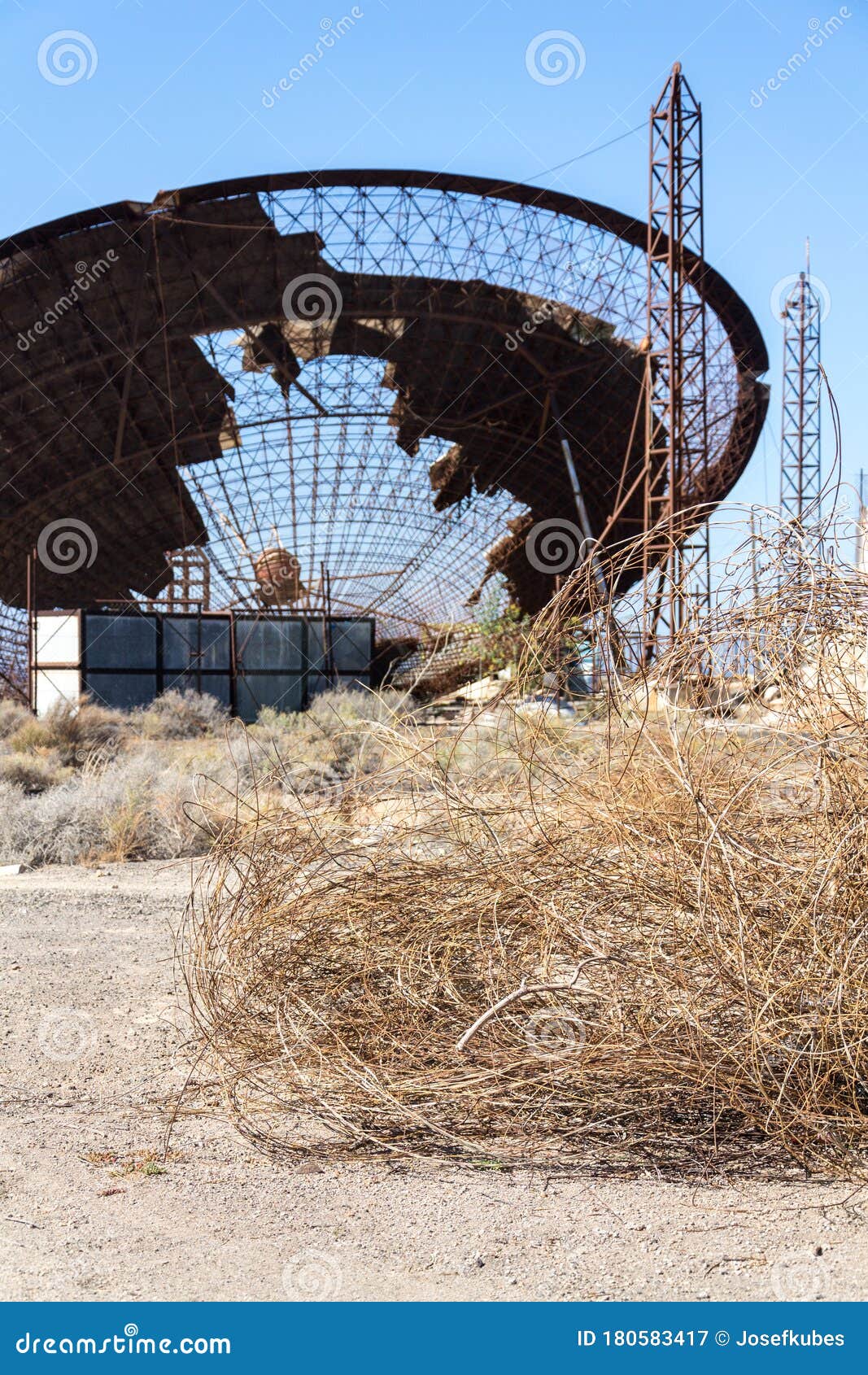 old satellite dish antenna in dry adir land near el medano, tenerife, canary islands, spain, telecommunication